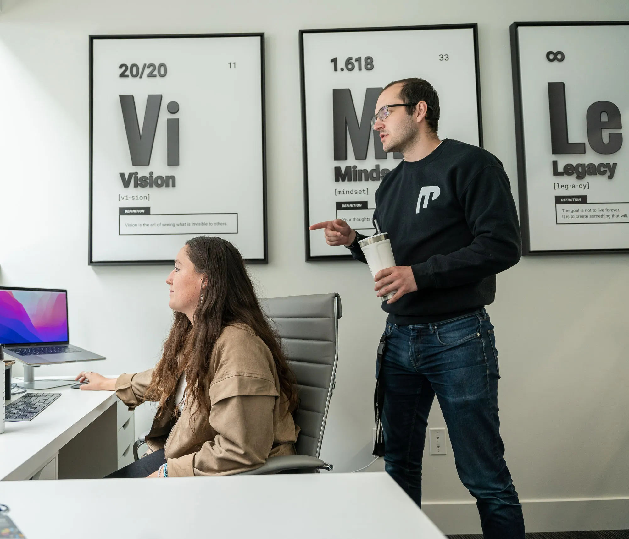 Two people working together on a design project in an office