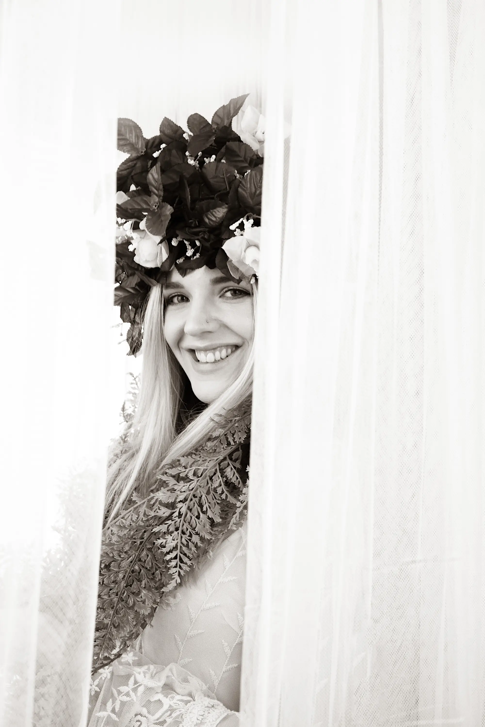 Black and white portrait of woman in wedding gown and flower veil