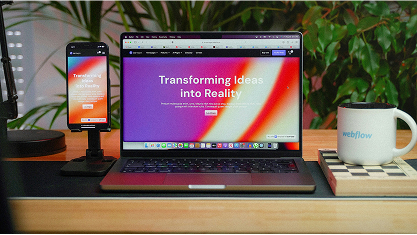 A laptop and phone displaying a colourful website in its mobile and desktop resolutions