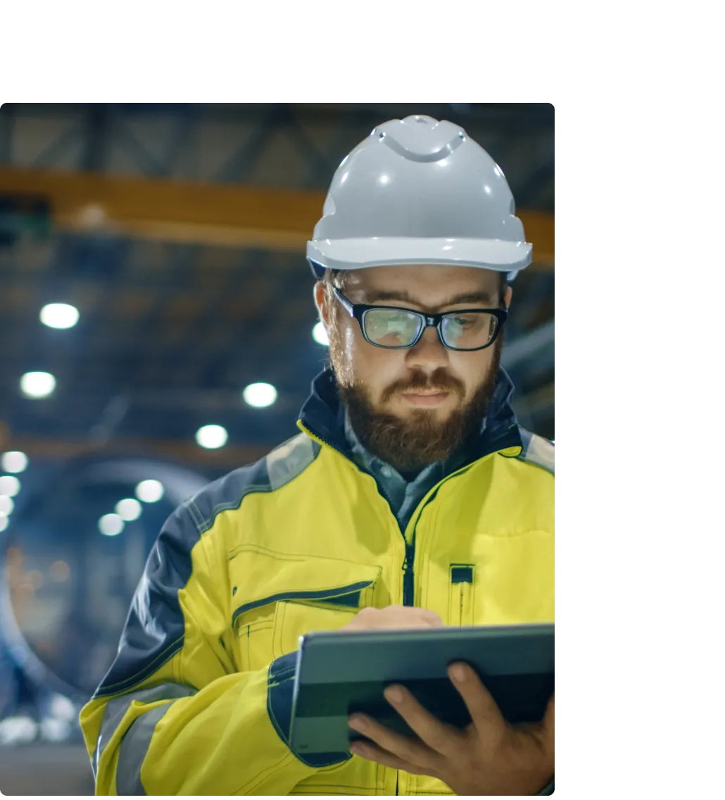 Image of maintenance worker looking at MaintainX application on tablet device