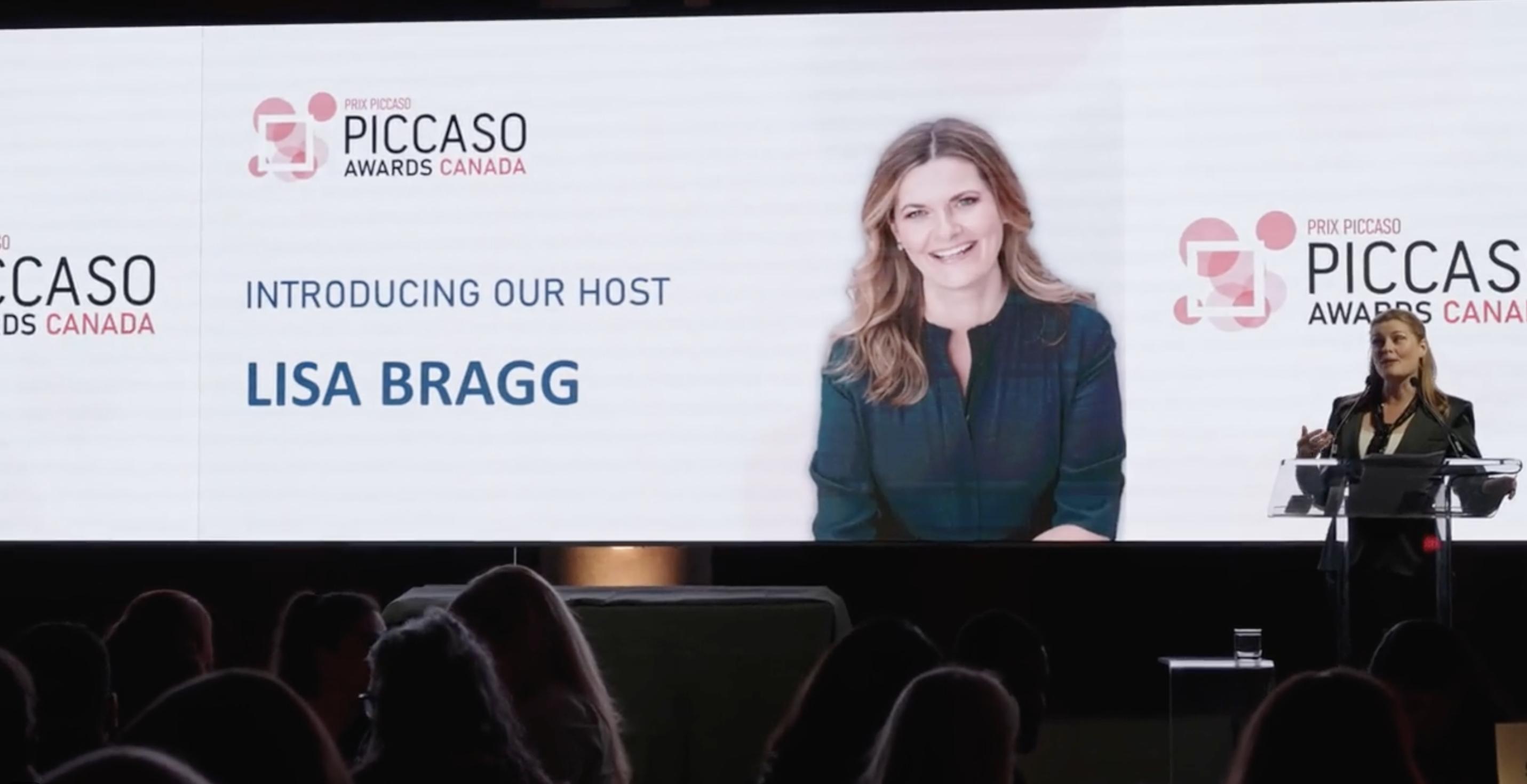 Lisa Bragg hosting the Piccaso Awards Canada from the podium.