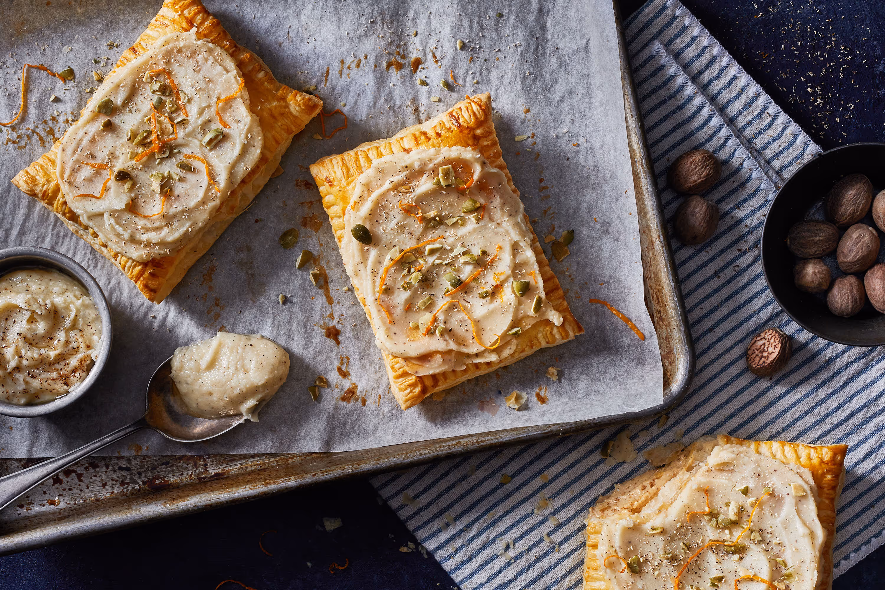 A photo of homemade breakfast pastries, you know, like ones. you'd put in a toaster. Topped with pistachios. Shot by Christi Chambers.