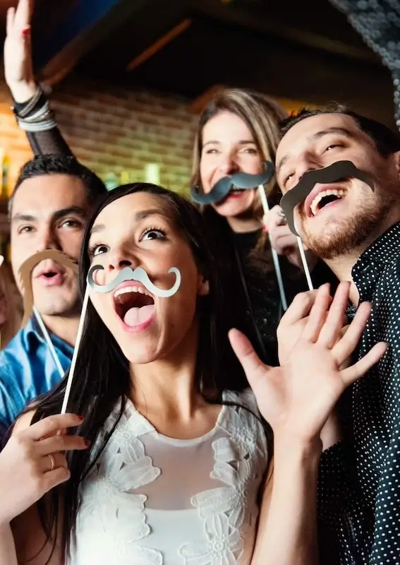 Friends posing for a photo with fake mustaches
