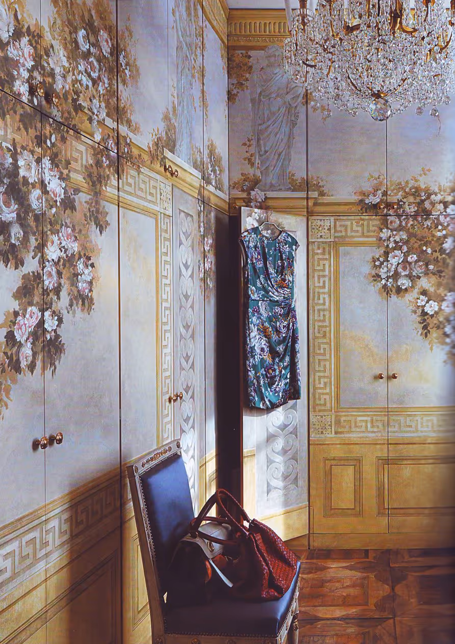 Floral wall mural by London painter in a charming interior with antique chair, handbags and a flower-patterned dress, showcasing custom hand-painted art and classical decorative design.