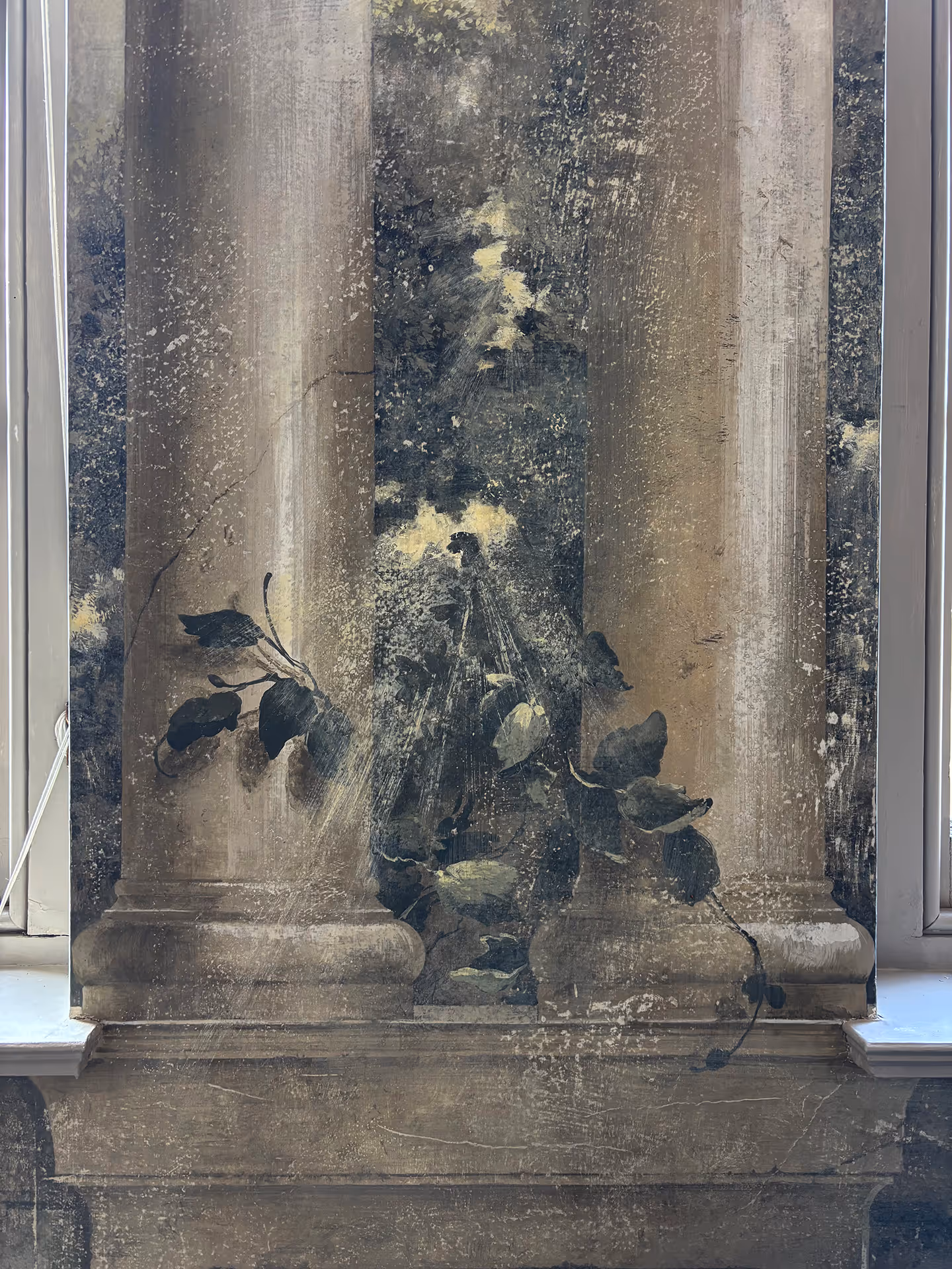 Classical mural by a London mural painter depicting two Roman columns with a young climbing plant between them, artistically stylized with expressive white brush strokes.