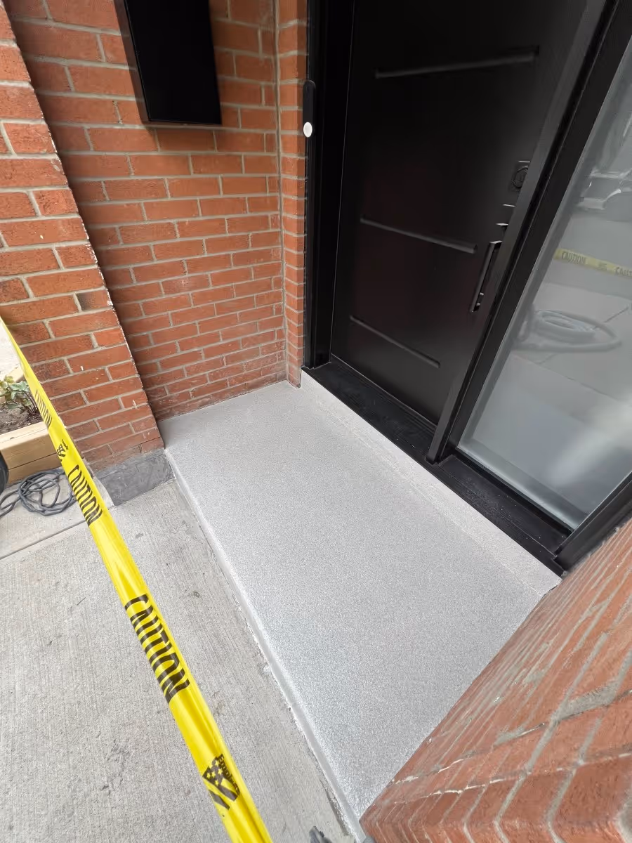 Front door concrete with fresh polyaspartic flake floor coating