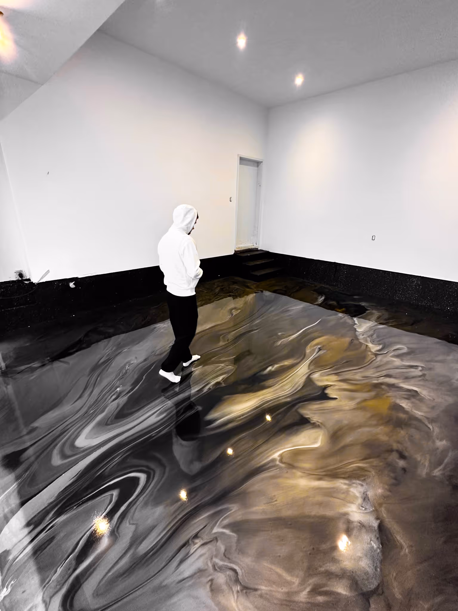 Metallic epoxy flooring in Tampa Florida with the contractor walking on it