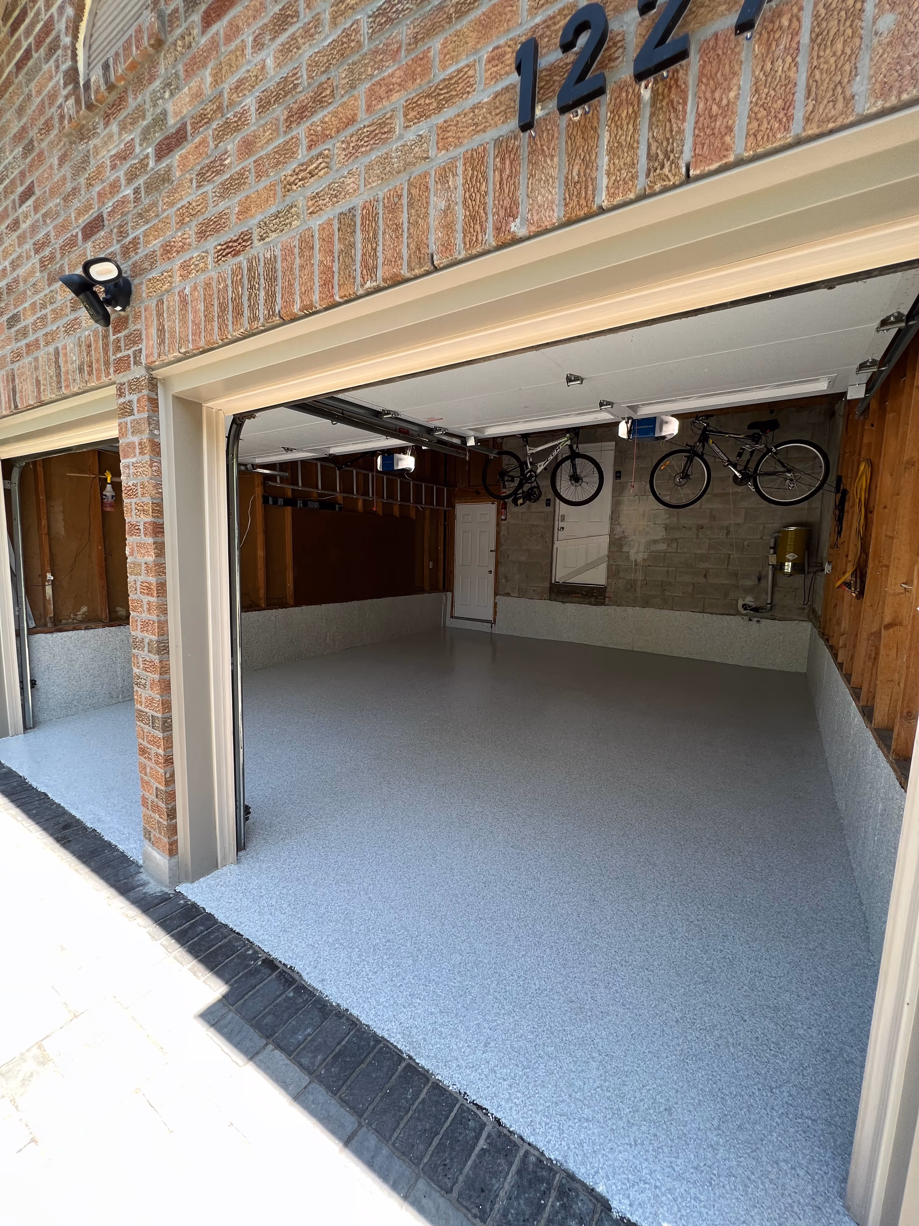 2 car garage with grey epoxy flooring