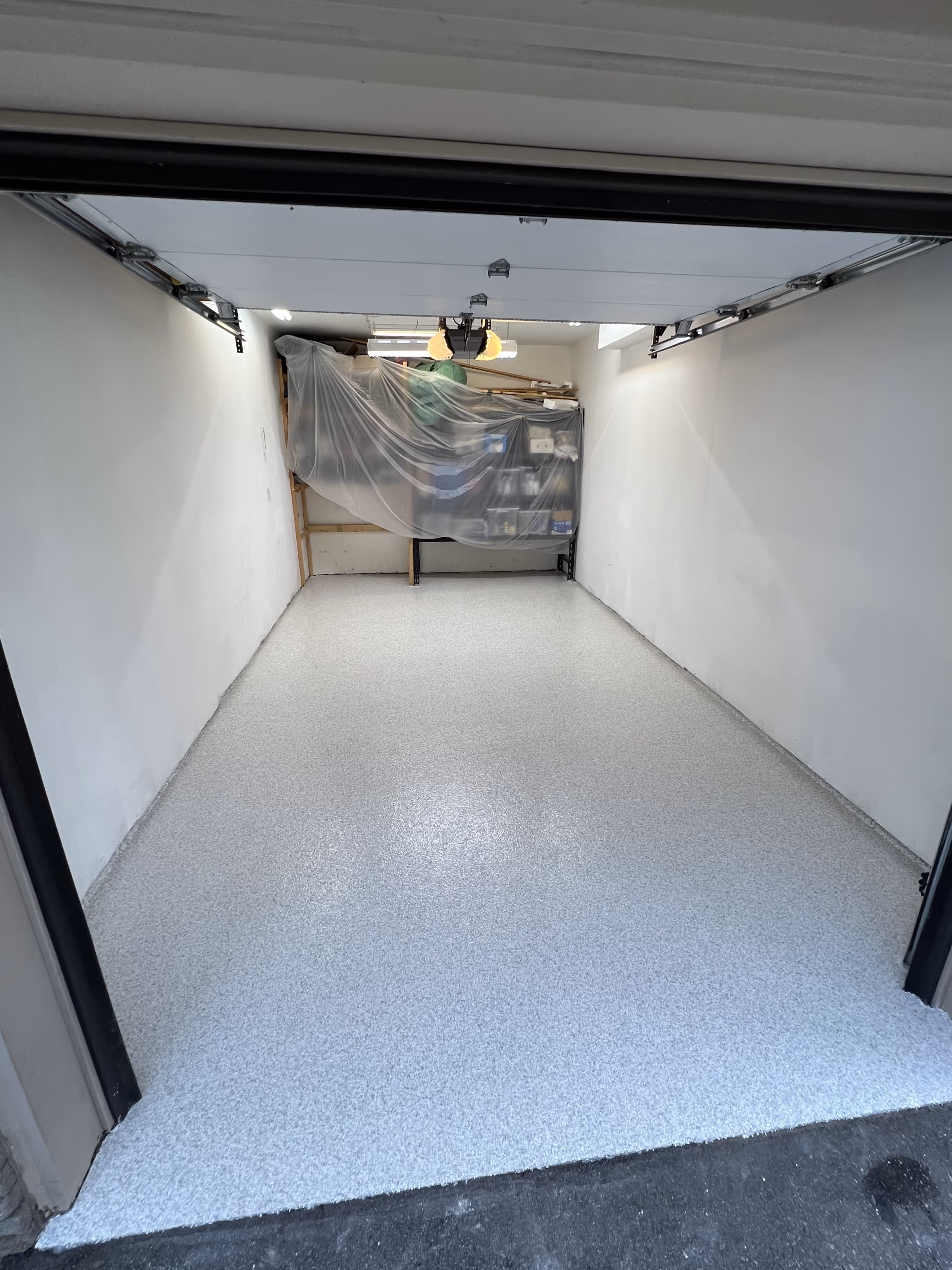 White and grey epoxy flake floor inside a single car garage in Tampa