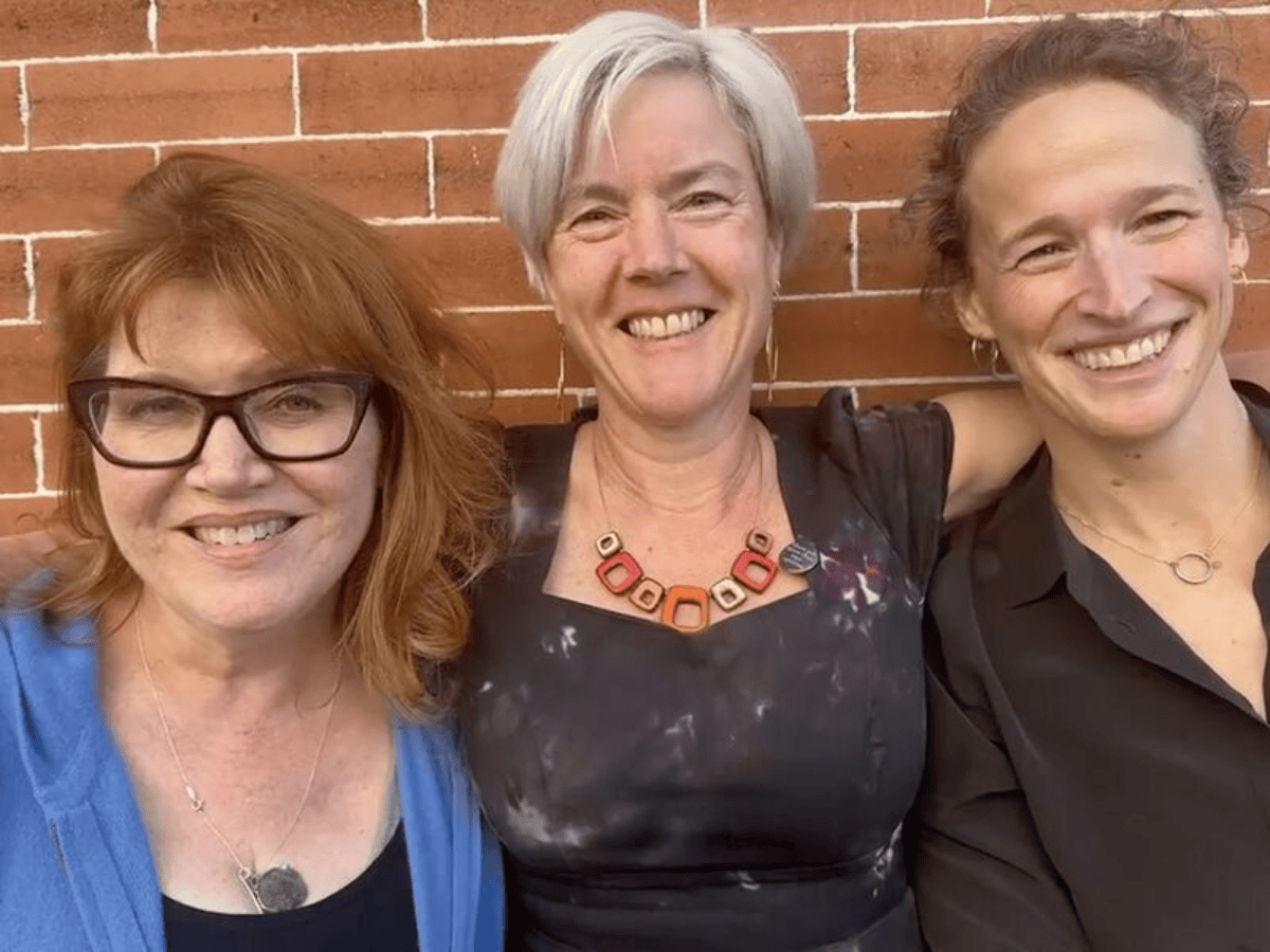 Caitlin Walker, Emily Stifler Wolfe, Erin Randall stand in front of a brick wall after a Clean Language training in Montana