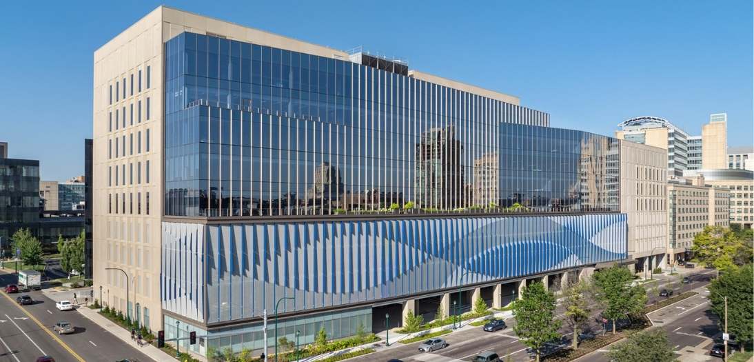 Exterior view of the Gary C. Werths Building at Siteman Cancer Center featuring DNA strand-inspired blue curtain wall and modern healthcare architecture in St. Louis