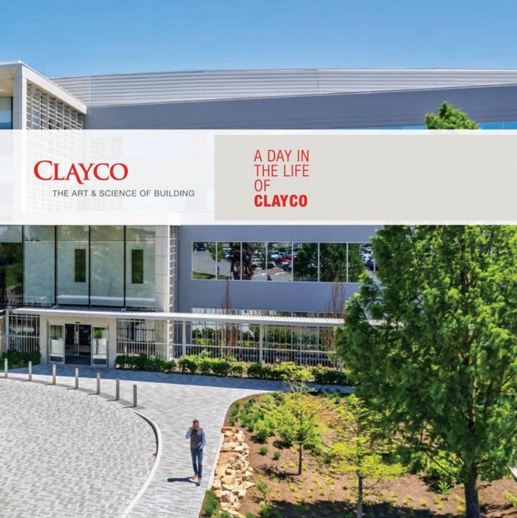 Modern office building with glass windows and landscaped entrance, featuring a person walking on a curved pathway. Text overlay reads 'Clayco – The Art & Science of Building' and 'A Day in the Life of Clayco.