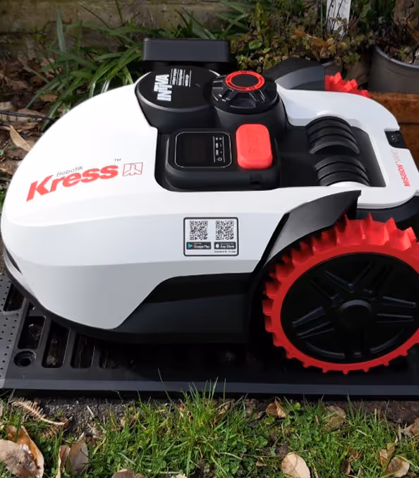 A autonomous mower on its charging pad.