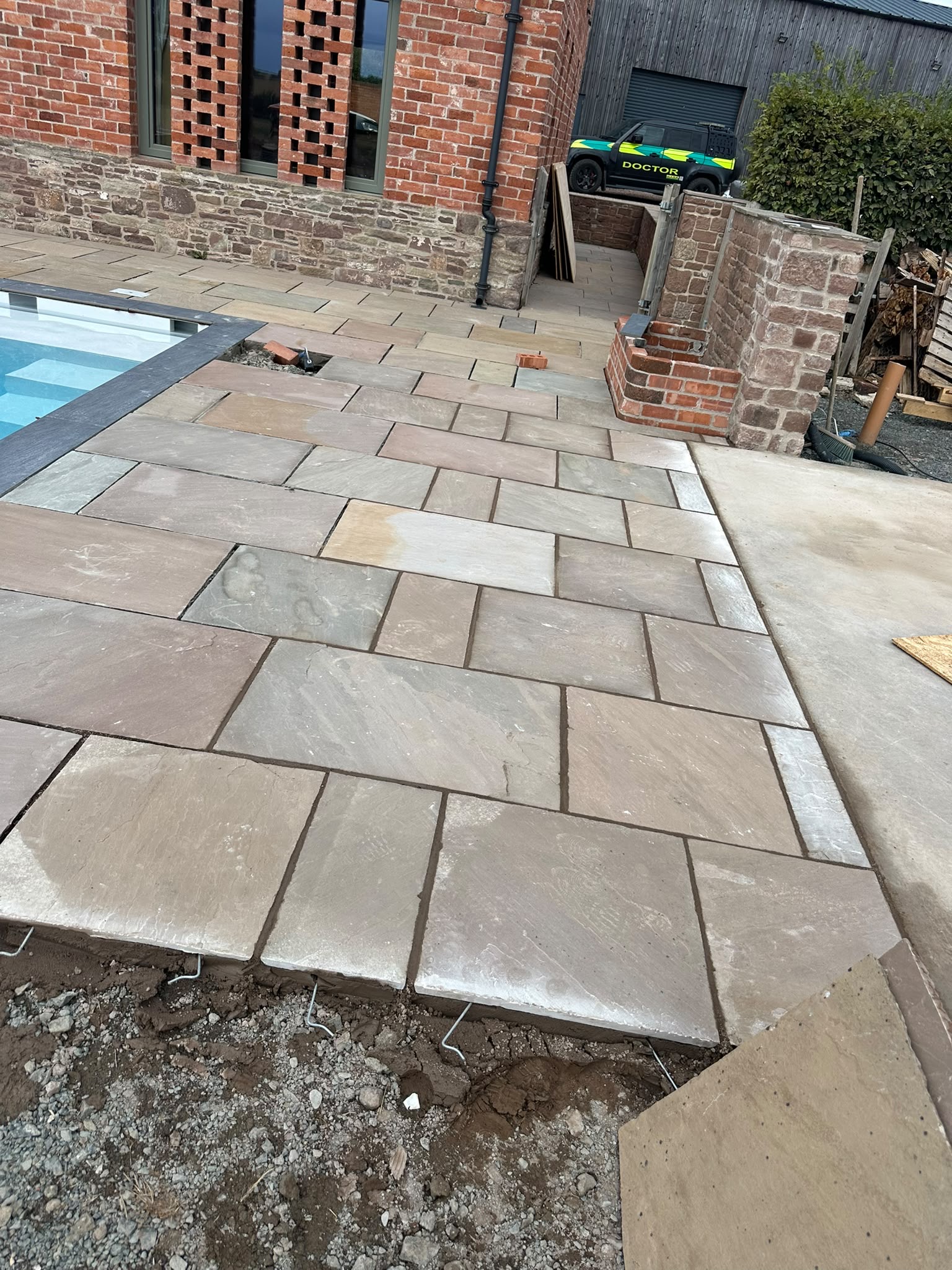 Paving being installed around the swimming pool