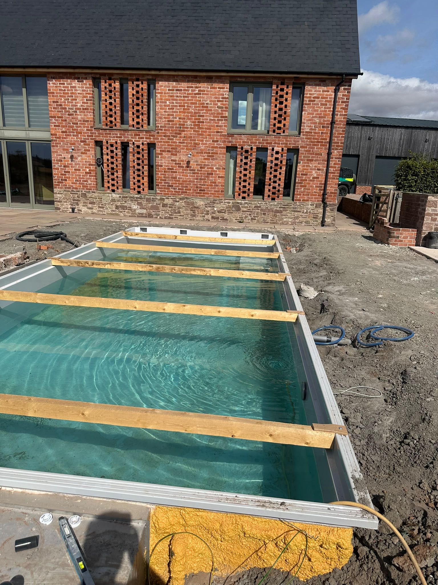 Pool shell in position with temporary bracing during installation