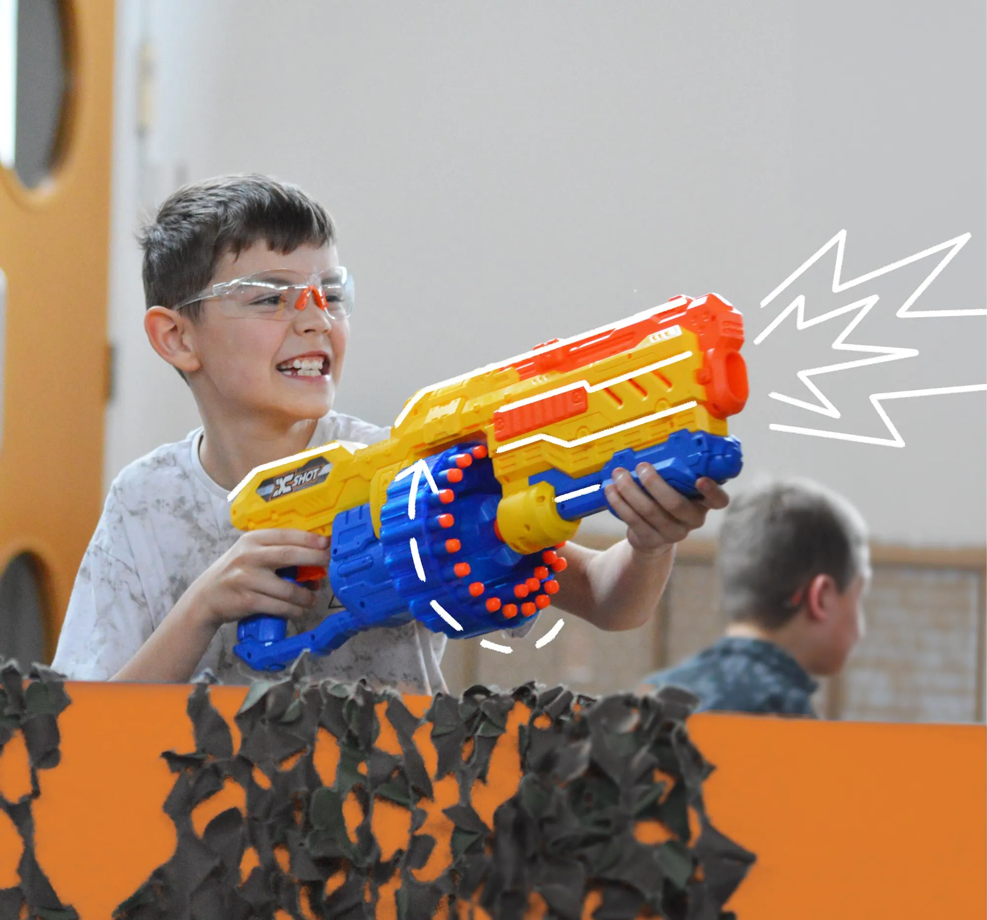 Young boy playing nerf ops activity