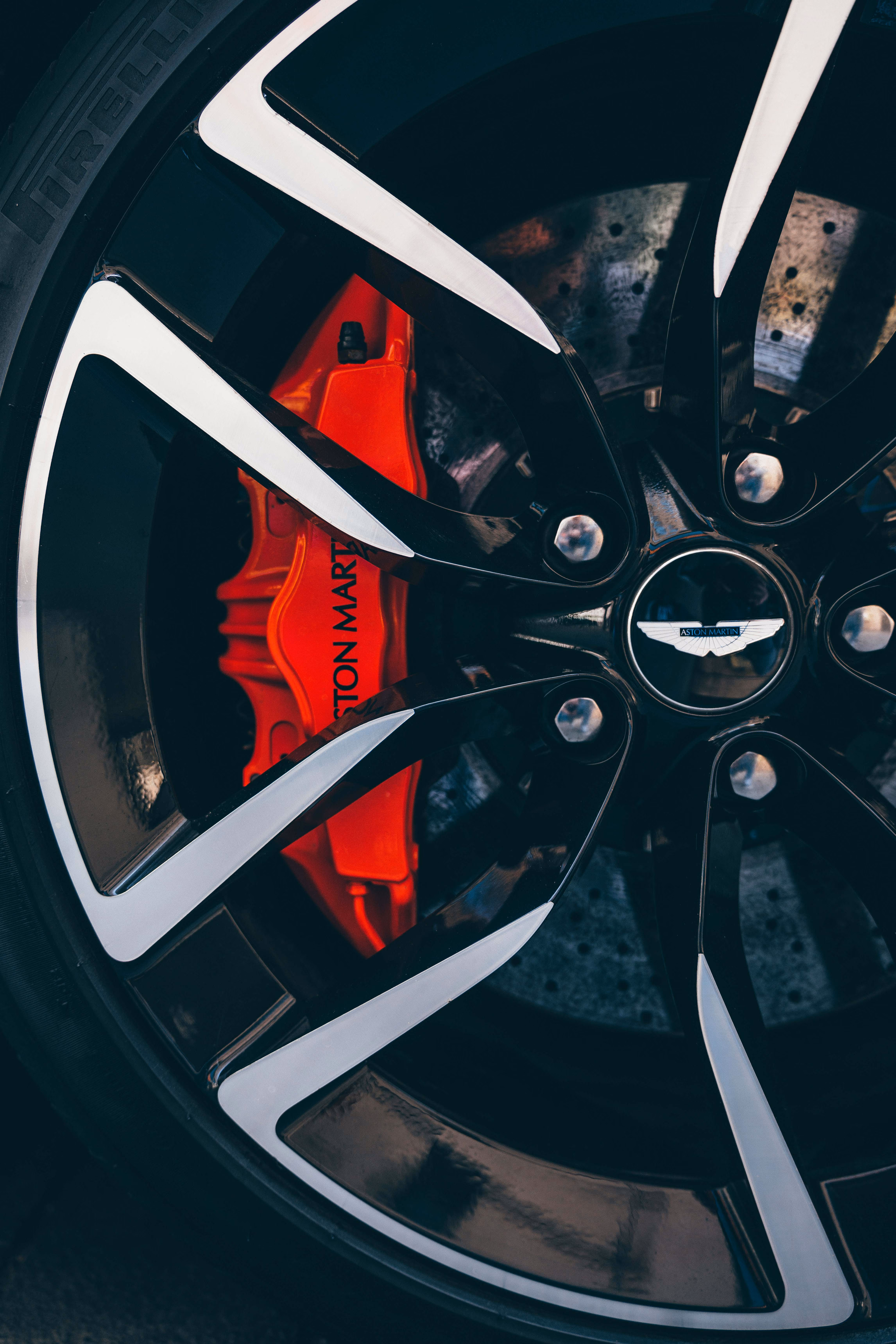 A close up image of an Aston Martin wheel and red brake calliper