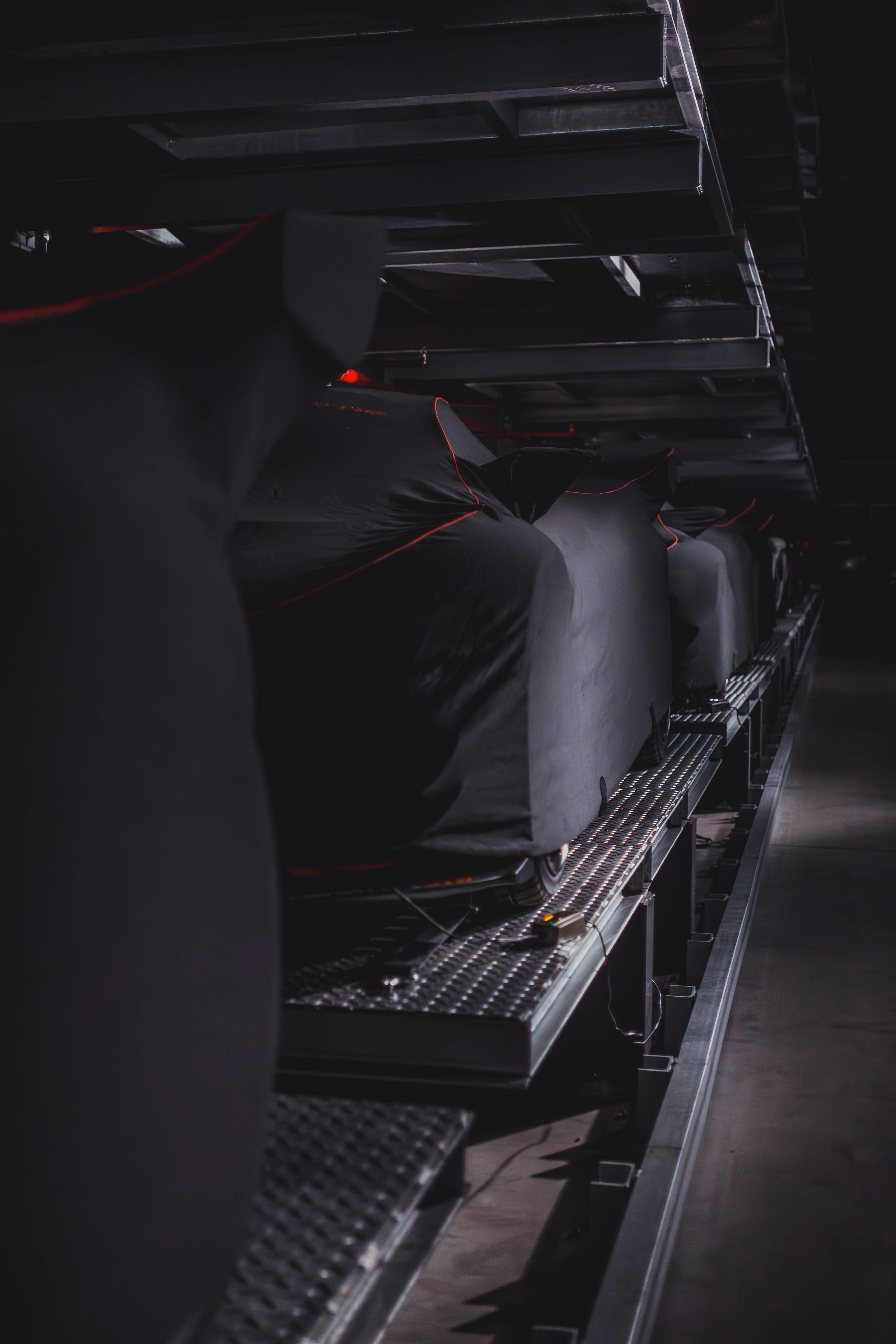 A secure dark vault with cars under cover