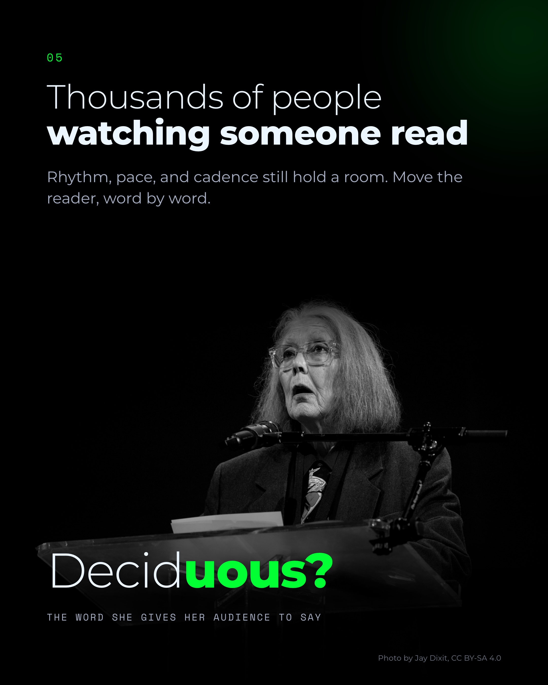 Anne Carson reading at a lectern, with the word Deciduous, which she gives her audience to say