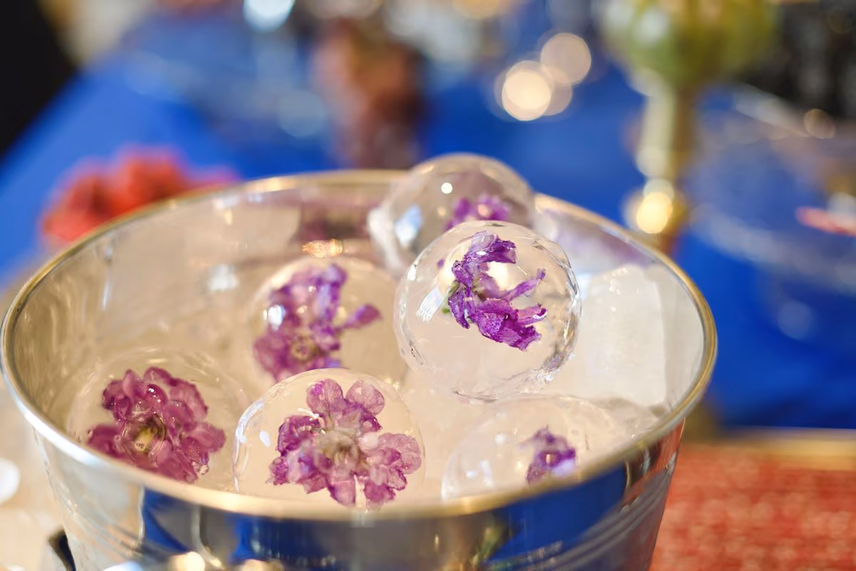 Ice spheres with frozen purple flowers in a silver bowl at Nir Eyal's Beyond Belief keynote in Prague
