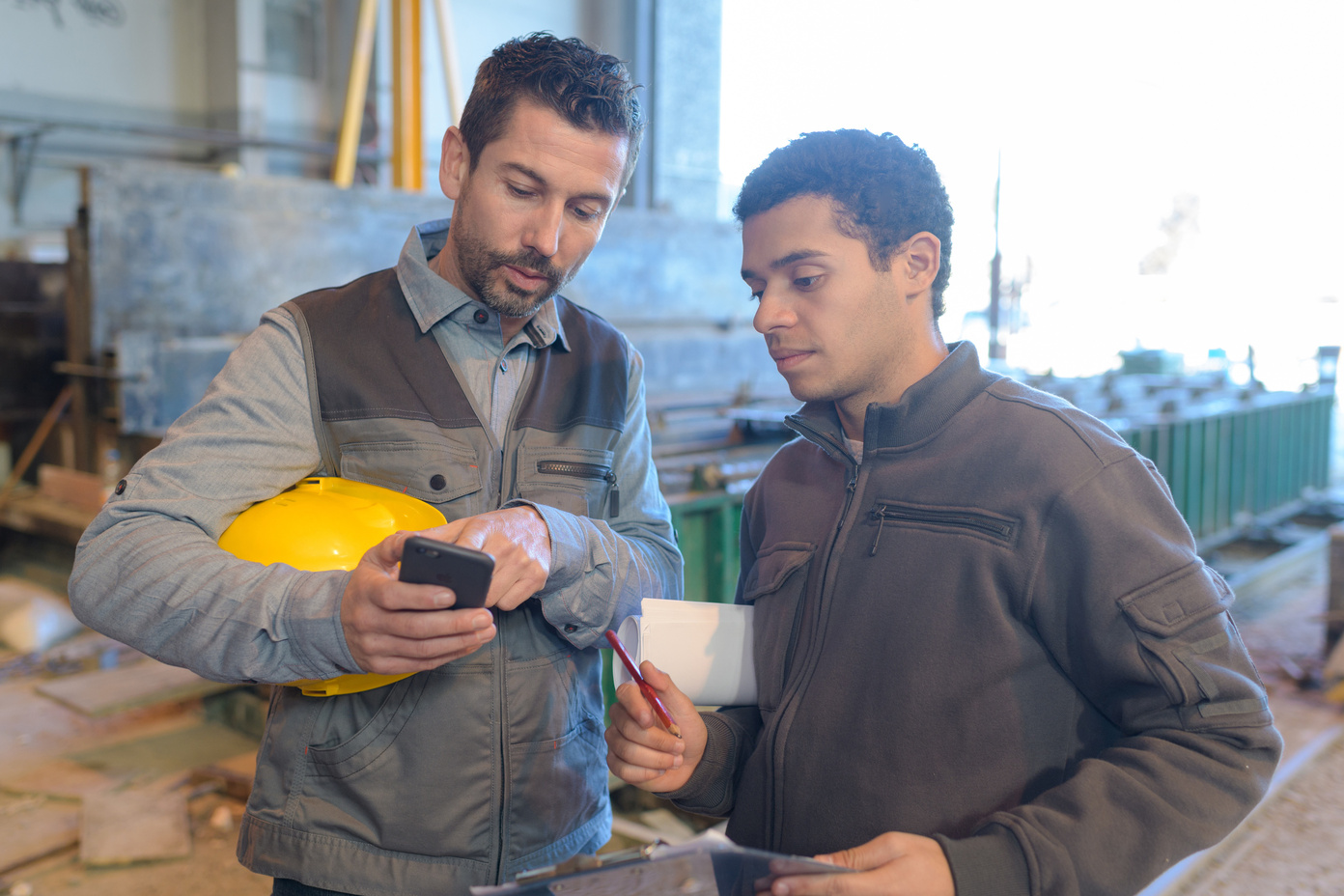 Two team members looking at their mobile CMMS.