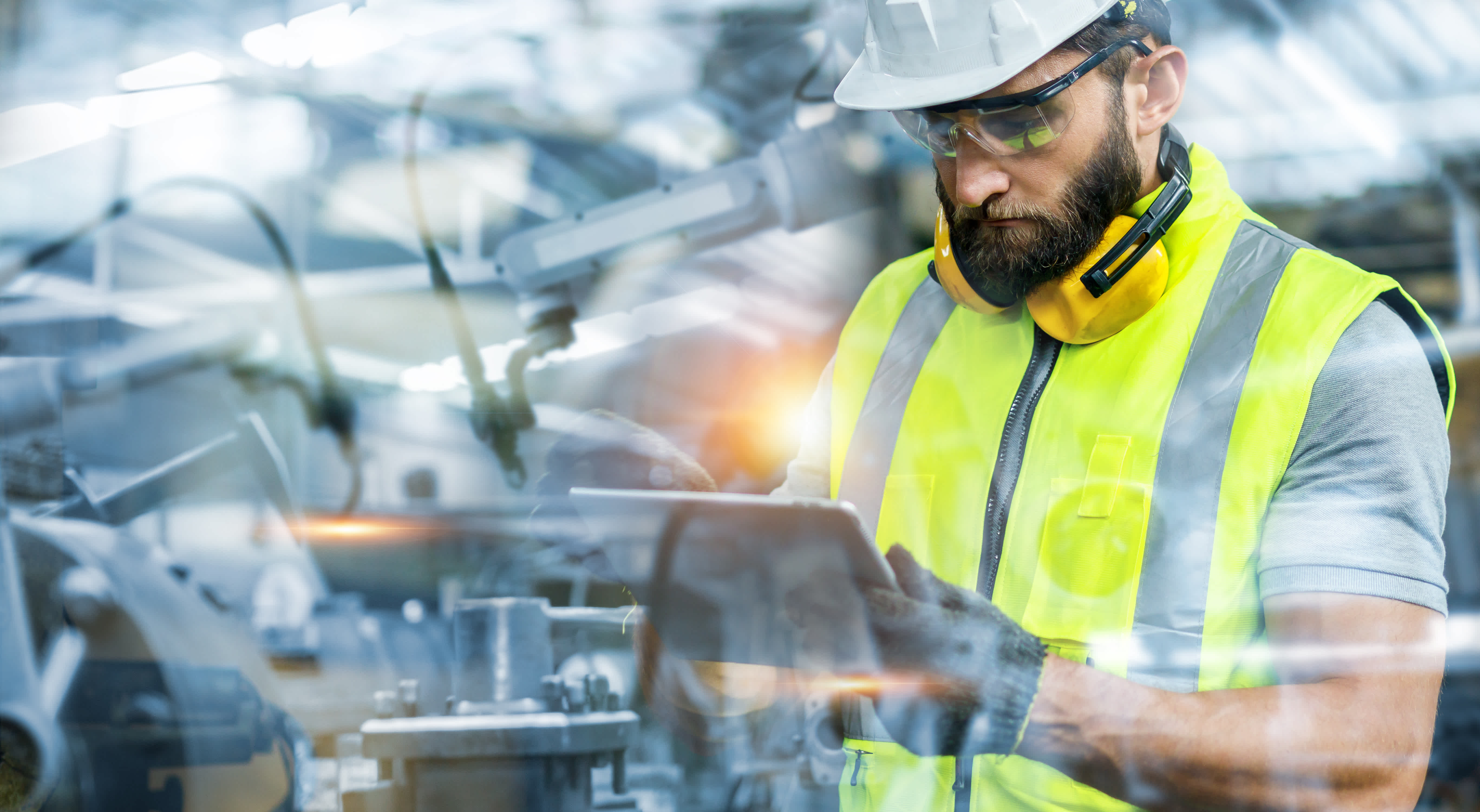 Image of maintenance worker looking at MaintainX application on tablet device