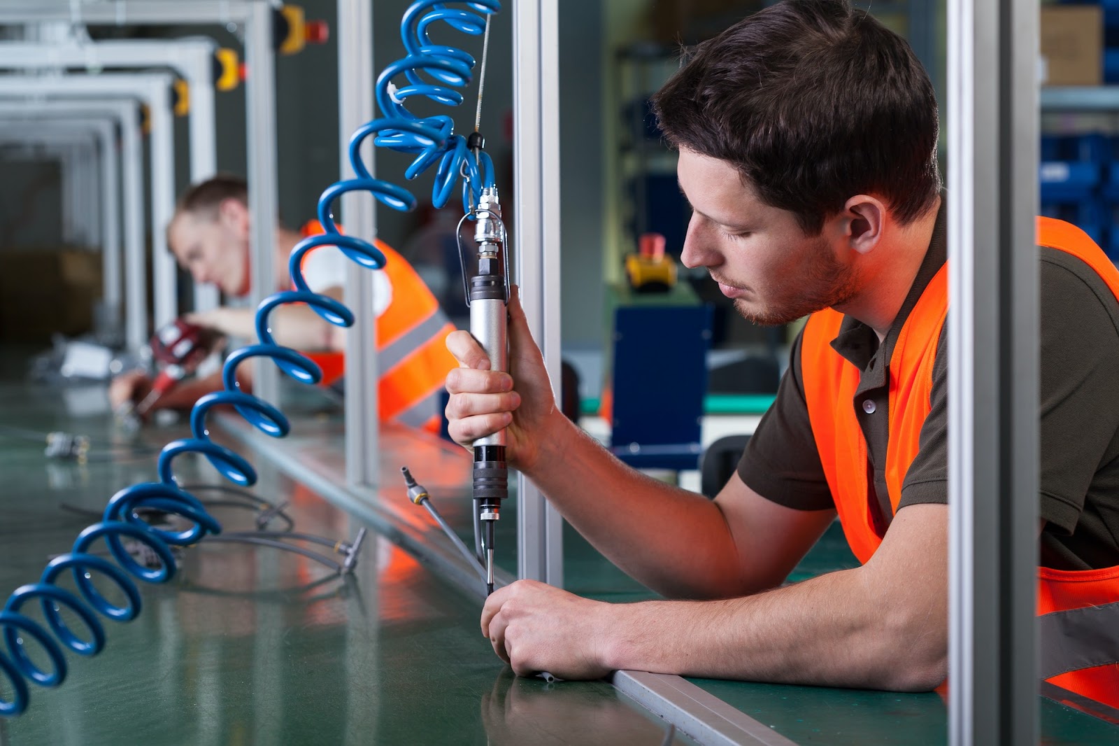 A manufacturing worker using equipment.