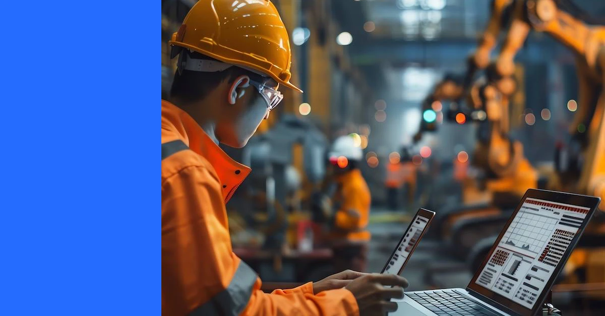 Maintenance leader looking at screen with reports in a manufacturing facility.