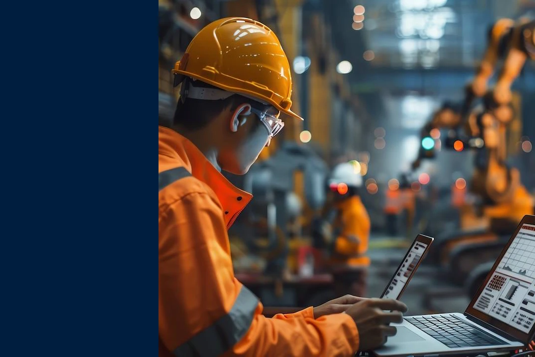 Maintenance leader looking at screen with reports in a manufacturing facility.