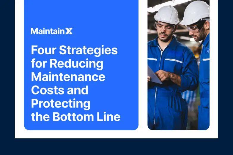 Two technicians reviewing a tablet in a factory.