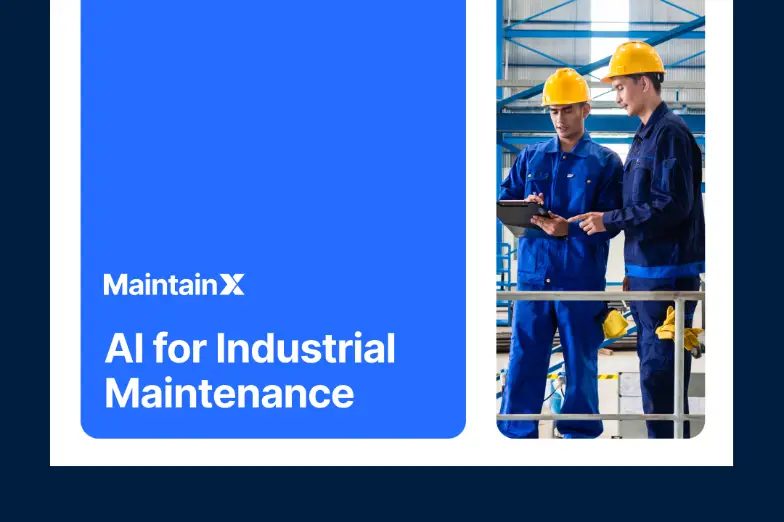 Industrial workers discussing data on a clipboard.