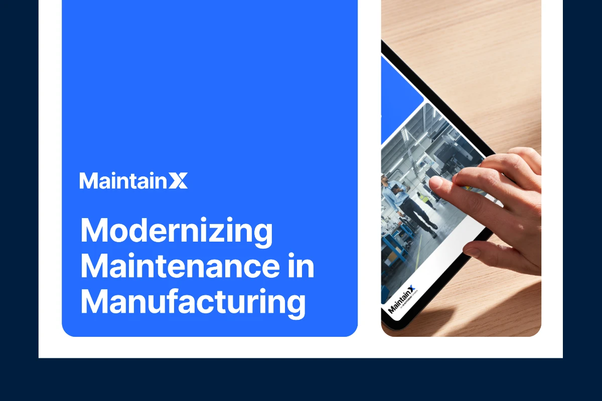 Hands holding a tablet displaying the cover of MaintainX's Modernizing Maintenance in Manufacturing ebook.