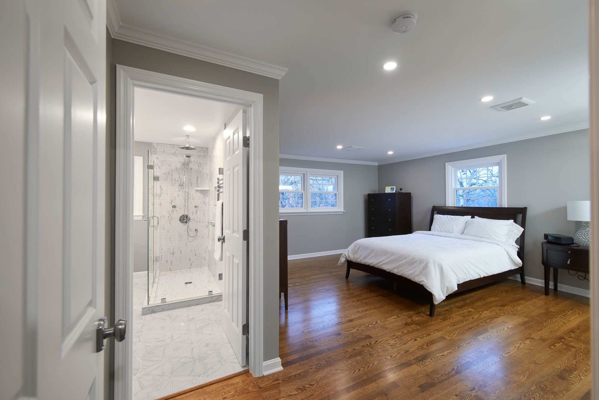 A master bathroom with the door leading open to a master bath.