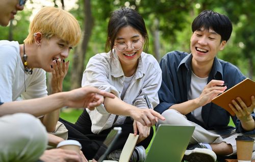 Women take a break and look at photos and social networks on phones during working day in the office