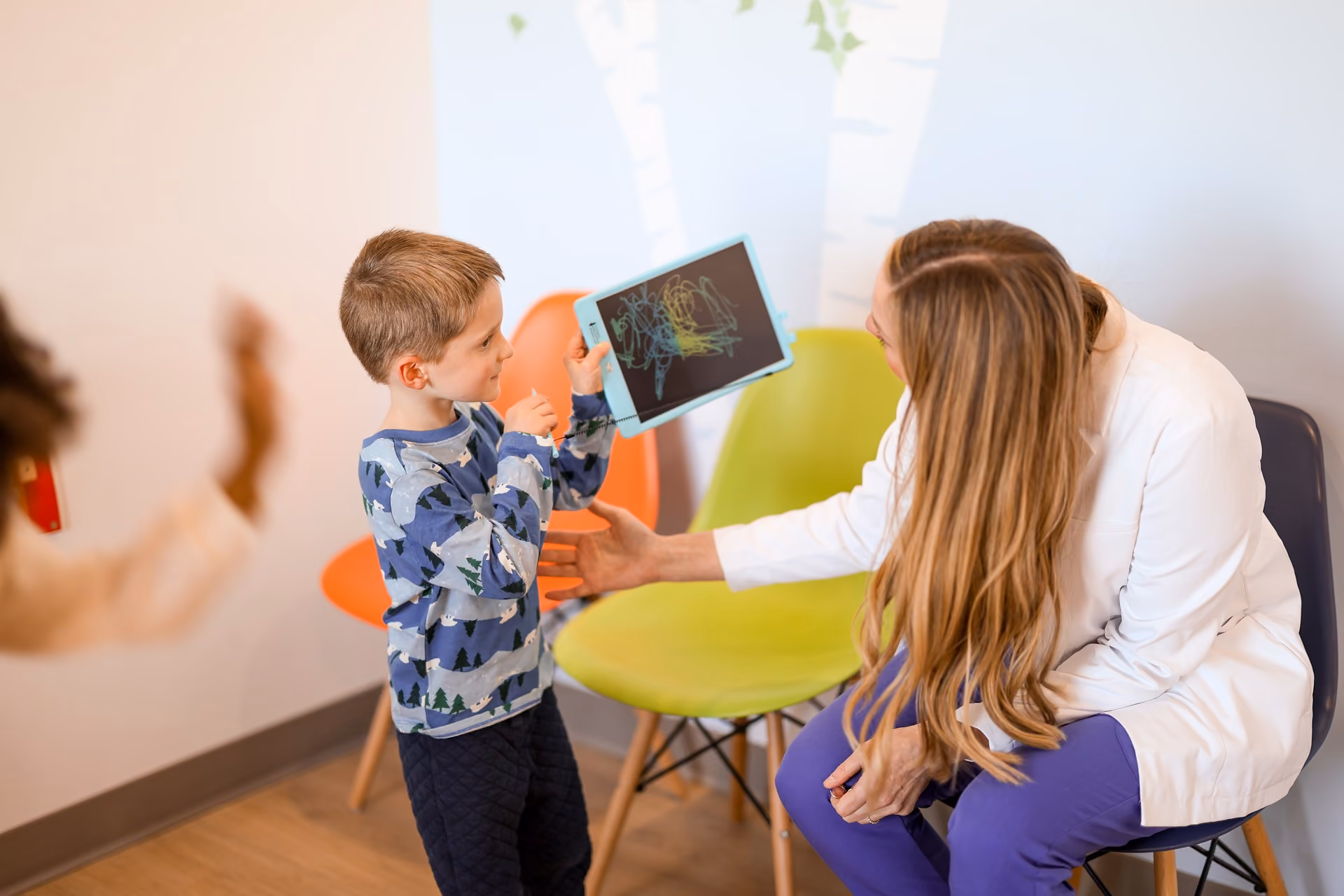 Dr. Breanna Barnes Playing with Kid in her Song Bird Pediatric Dentist Clinic