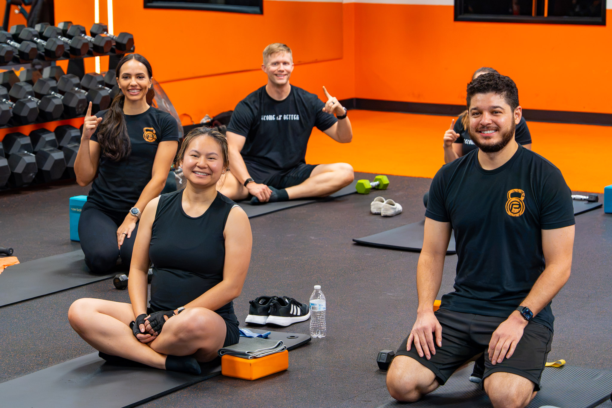 PRSVR Gym members smiling and giving thumbs up during a small group class