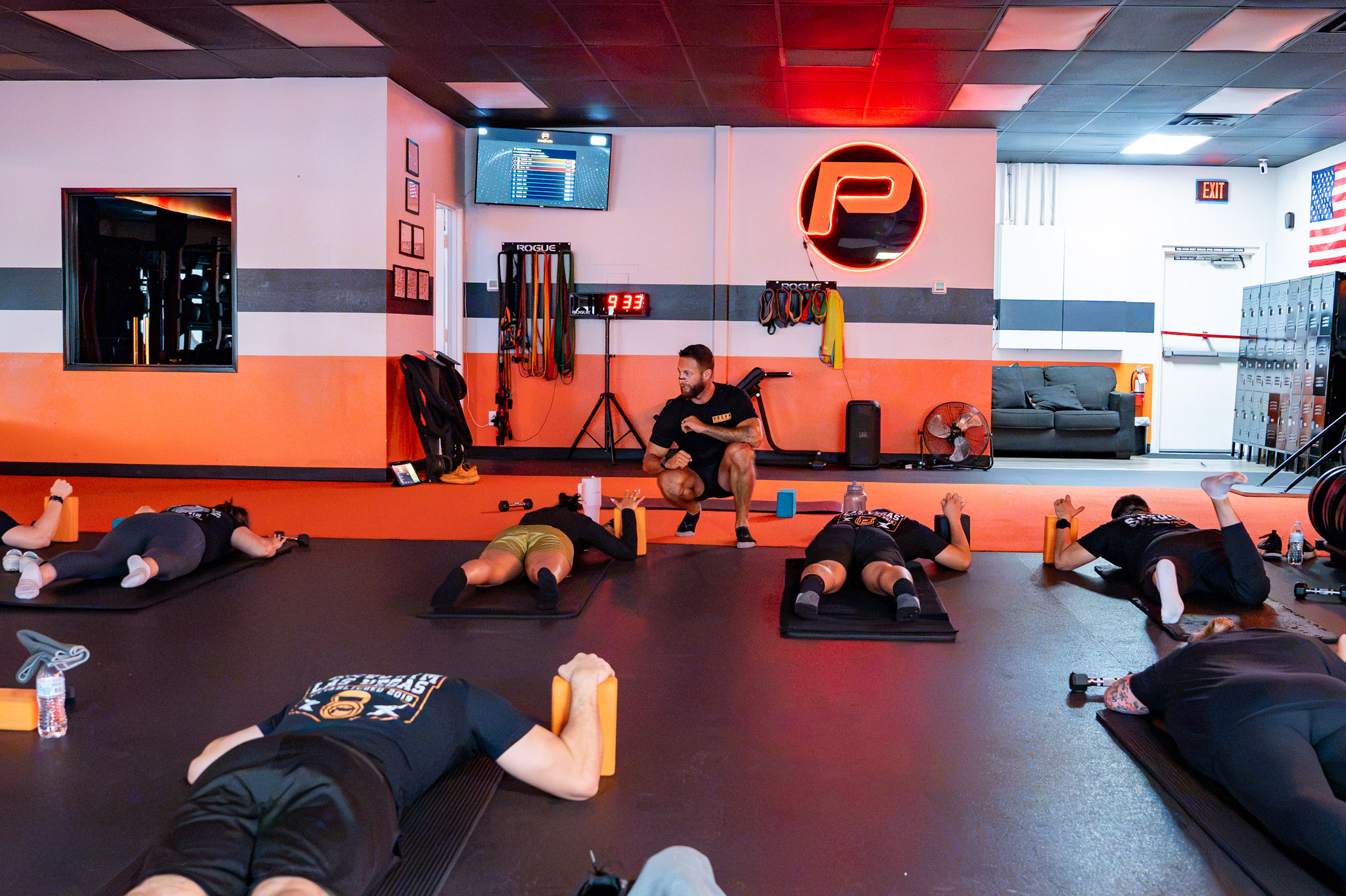 Small group training class in progress inside PRSVR Gym in Las Vegas under the glowing PRSVR logo