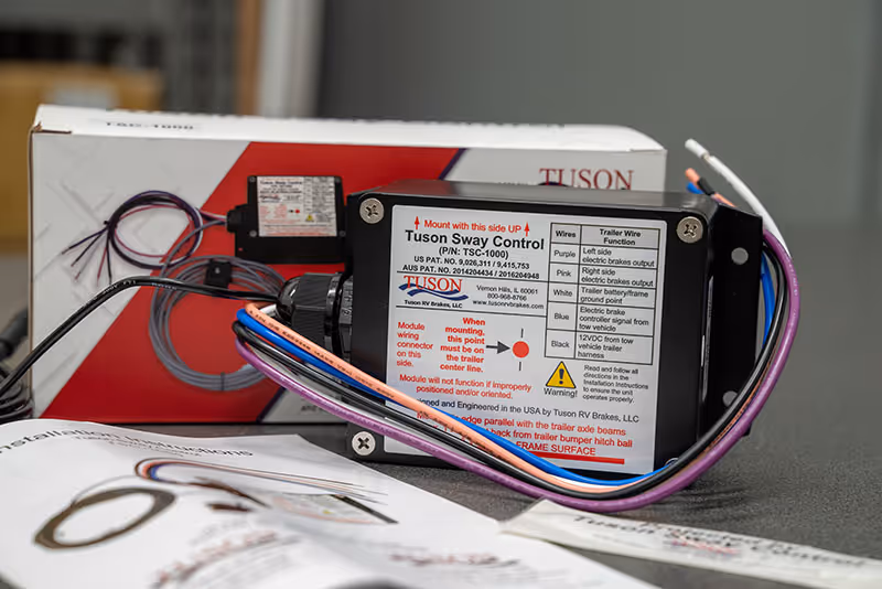 Tuson Sway Control device with wiring harness and instruction manual on a table.