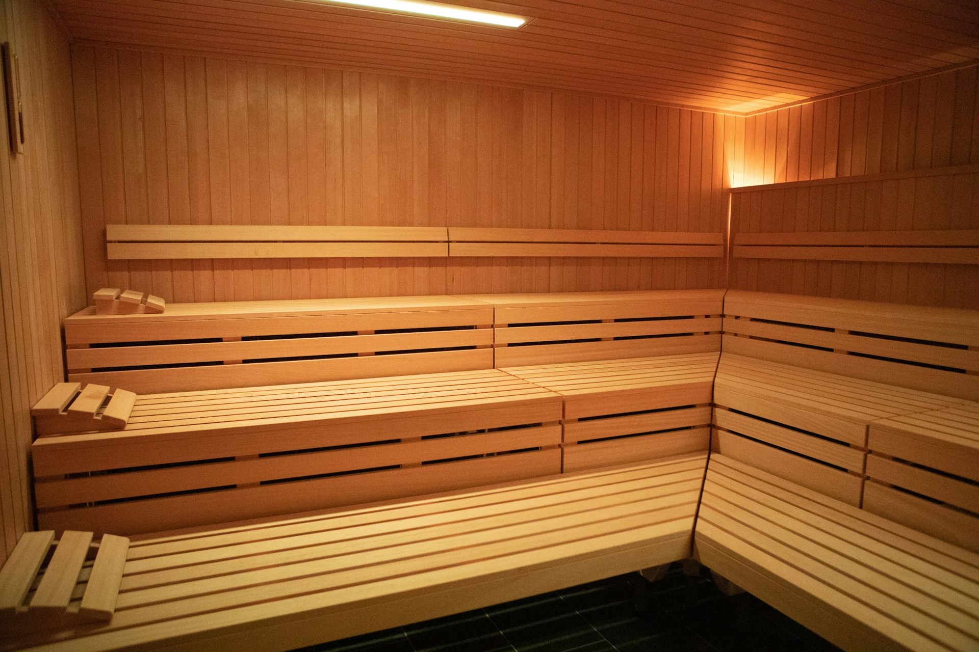 Wooden bench seating for groups in traditional style hot stone sauna