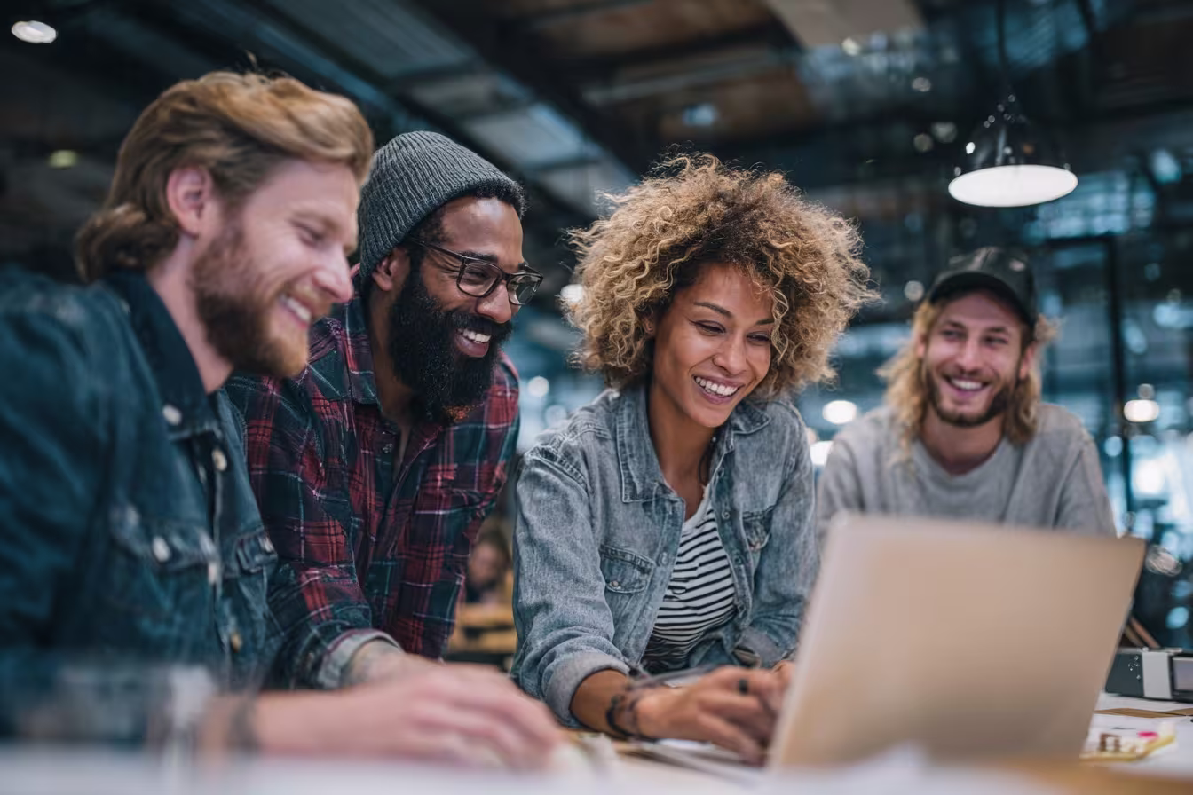 Diverse outsourced IT support team collaborating around AI-powered chatbot interface