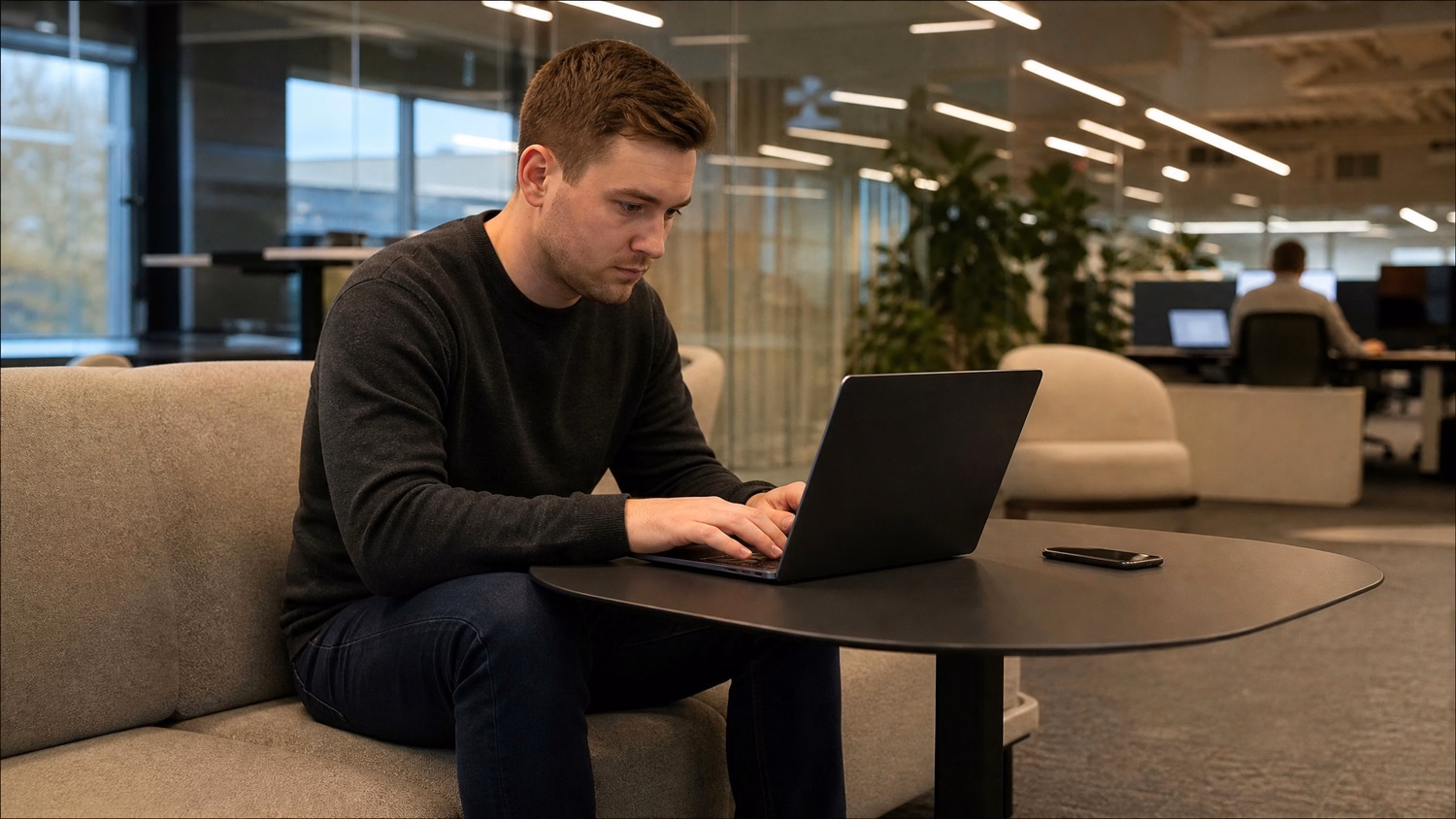 LOUNGE AREA LAPTOP An IT professional one person working on a laptop in a ca