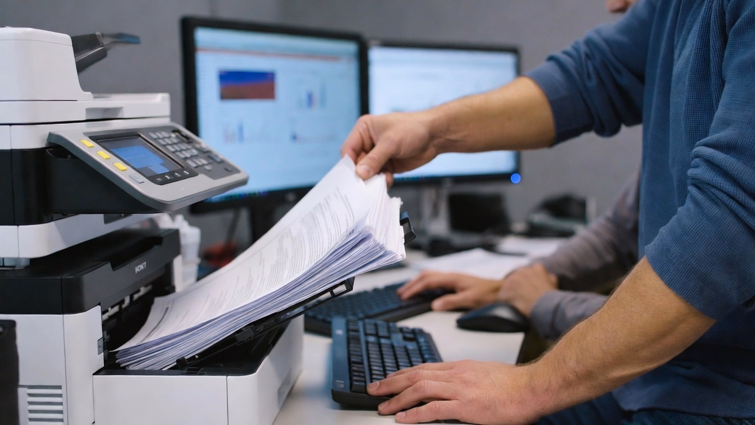IT professionals review network diagram on laptop at standing table