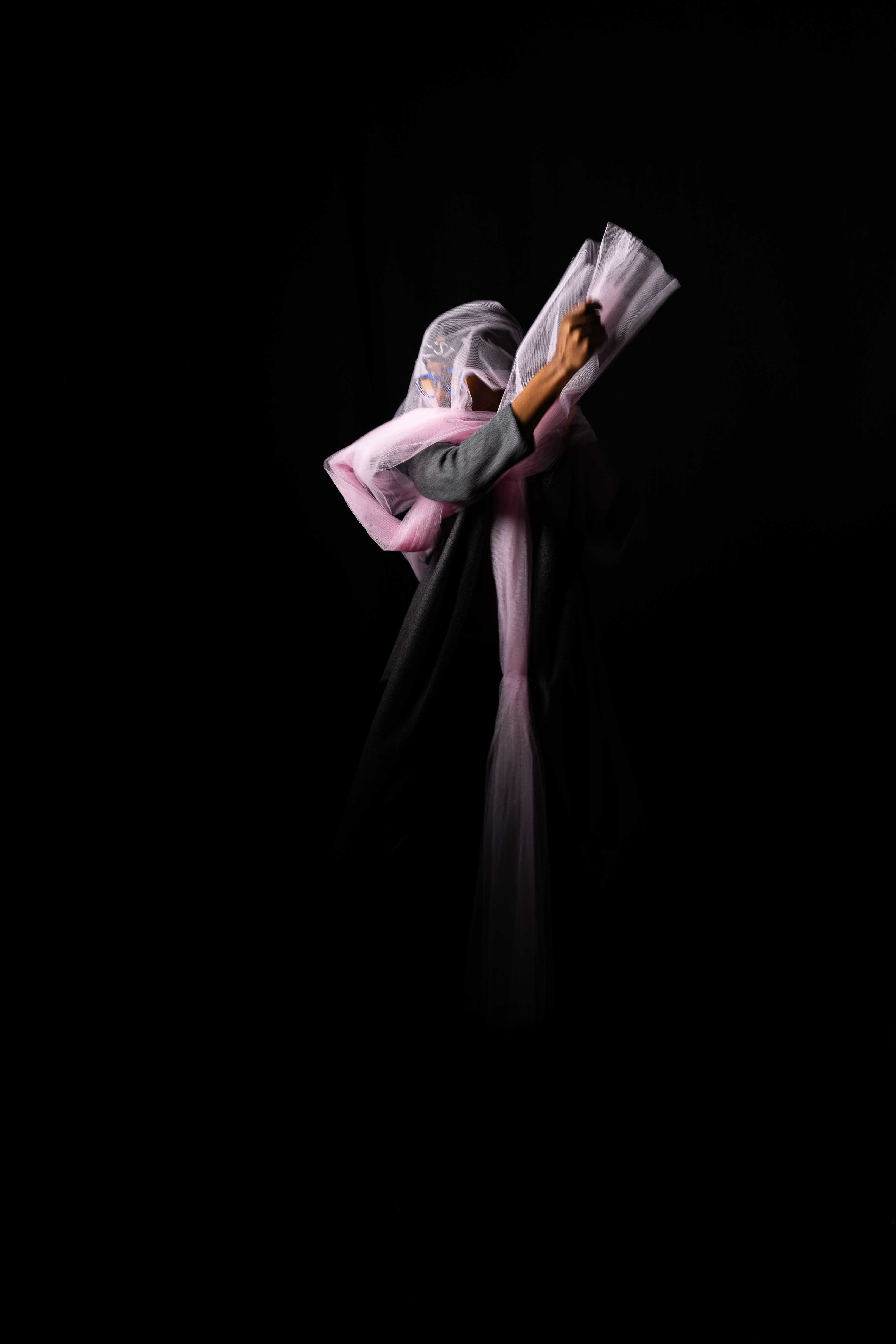 Tim by FADETOBLACK, studio portrait photography, image 10: Low-key studio portraits of a man against a black background, wrapped in flowing pink tulle