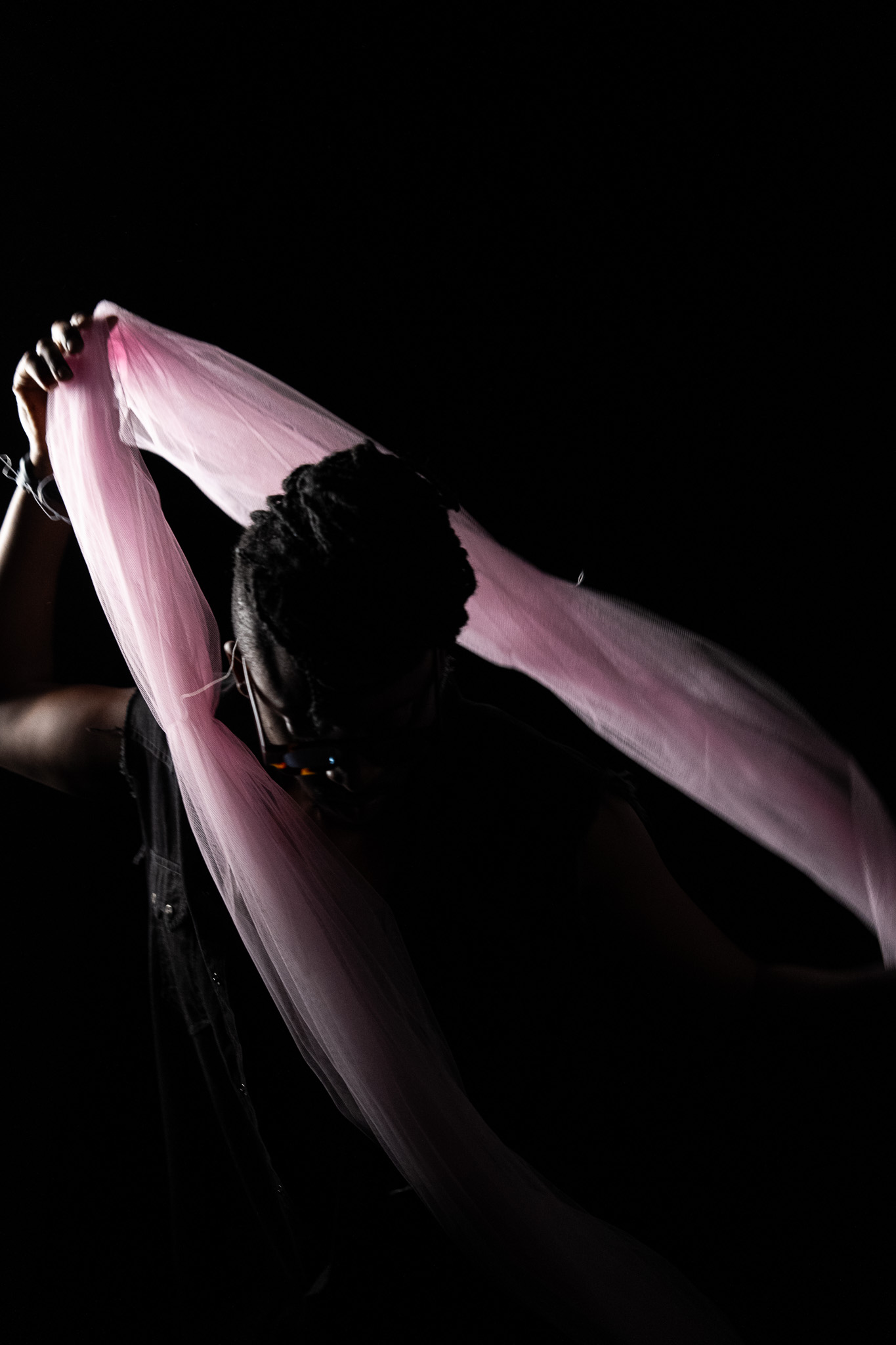 Tim by FADETOBLACK, studio portrait photography, image 25: Low-key studio portraits of a man against a black background, wrapped in flowing pink tulle