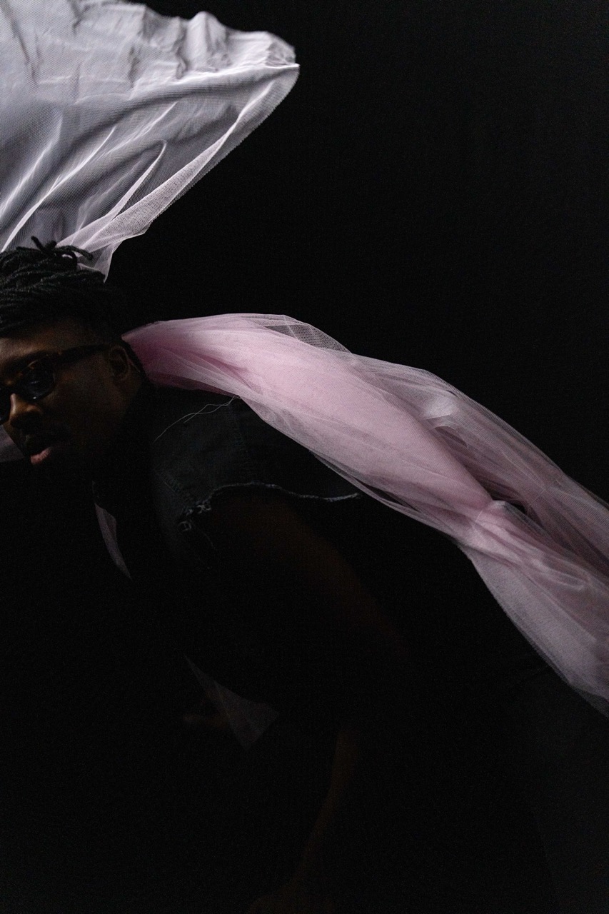 Tim by FADETOBLACK, studio portrait photography, image 22: Low-key studio portraits of a man against a black background, wrapped in flowing pink tulle
