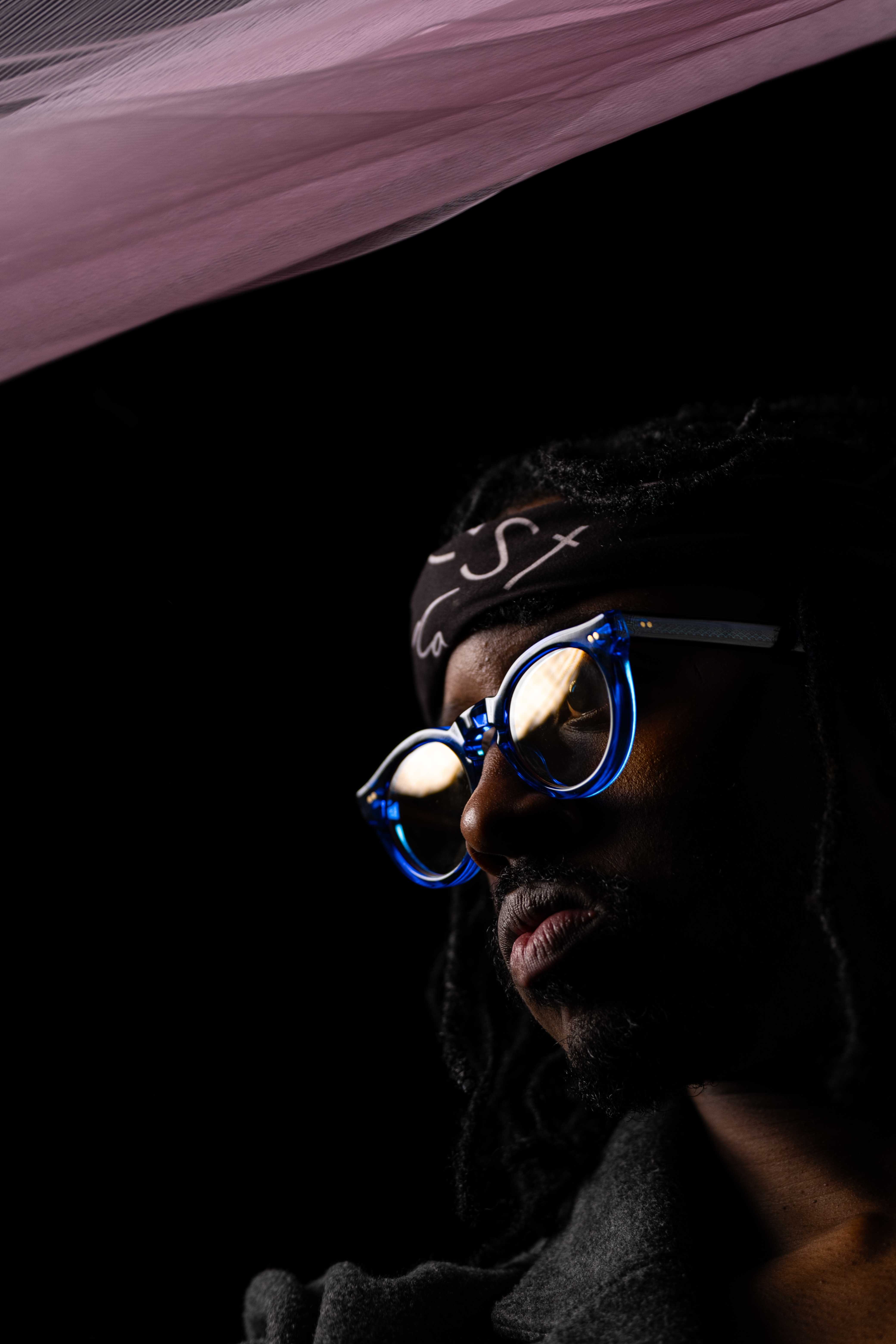 Tim by FADETOBLACK, studio portrait photography, image 17: Low-key studio portraits of a man against a black background, wrapped in flowing pink tulle