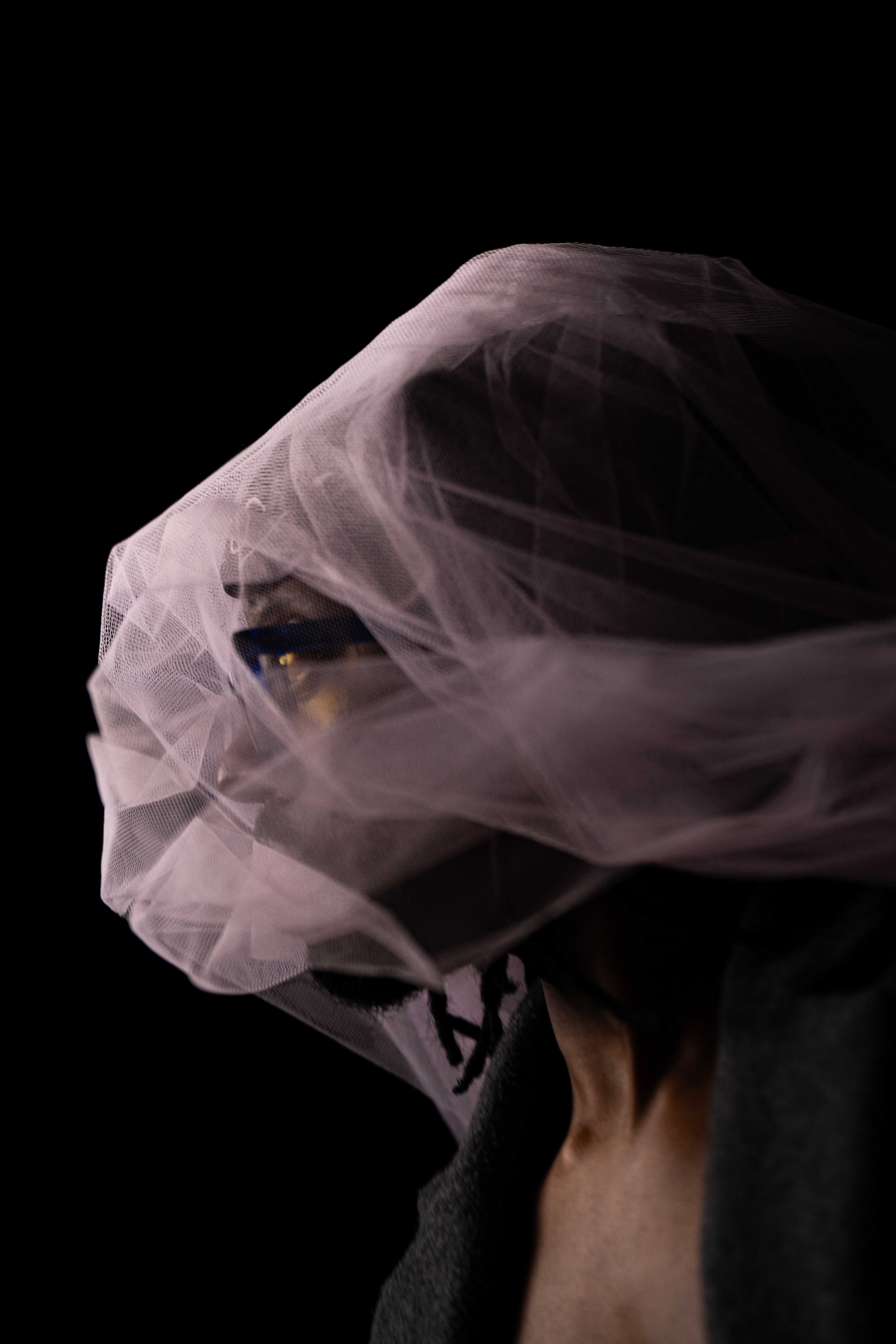 Tim by FADETOBLACK, studio portrait photography, image 8: Low-key studio portraits of a man against a black background, wrapped in flowing pink tulle