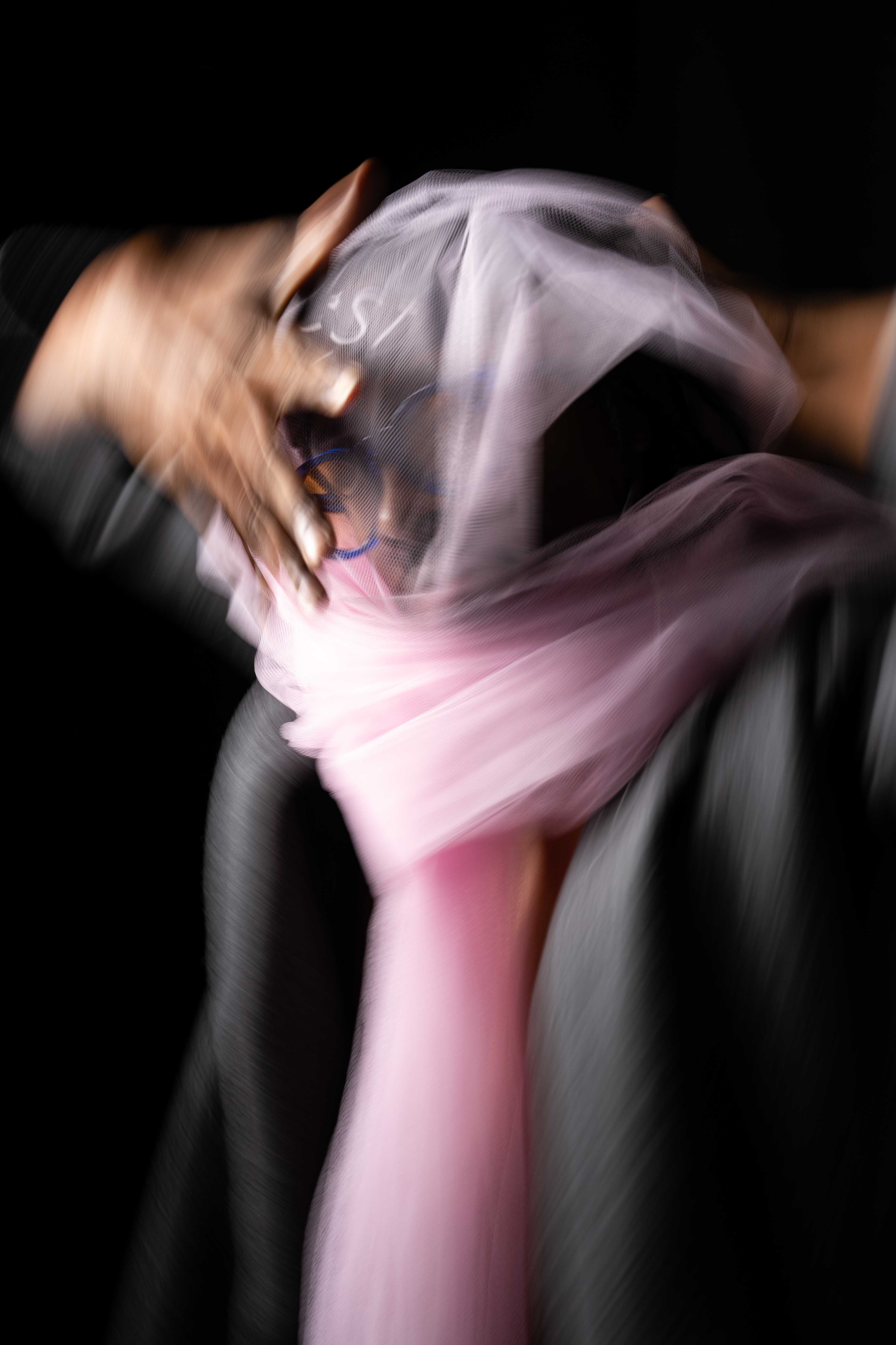 Tim by FADETOBLACK, studio portrait photography, image 21: Low-key studio portraits of a man against a black background, wrapped in flowing pink tulle