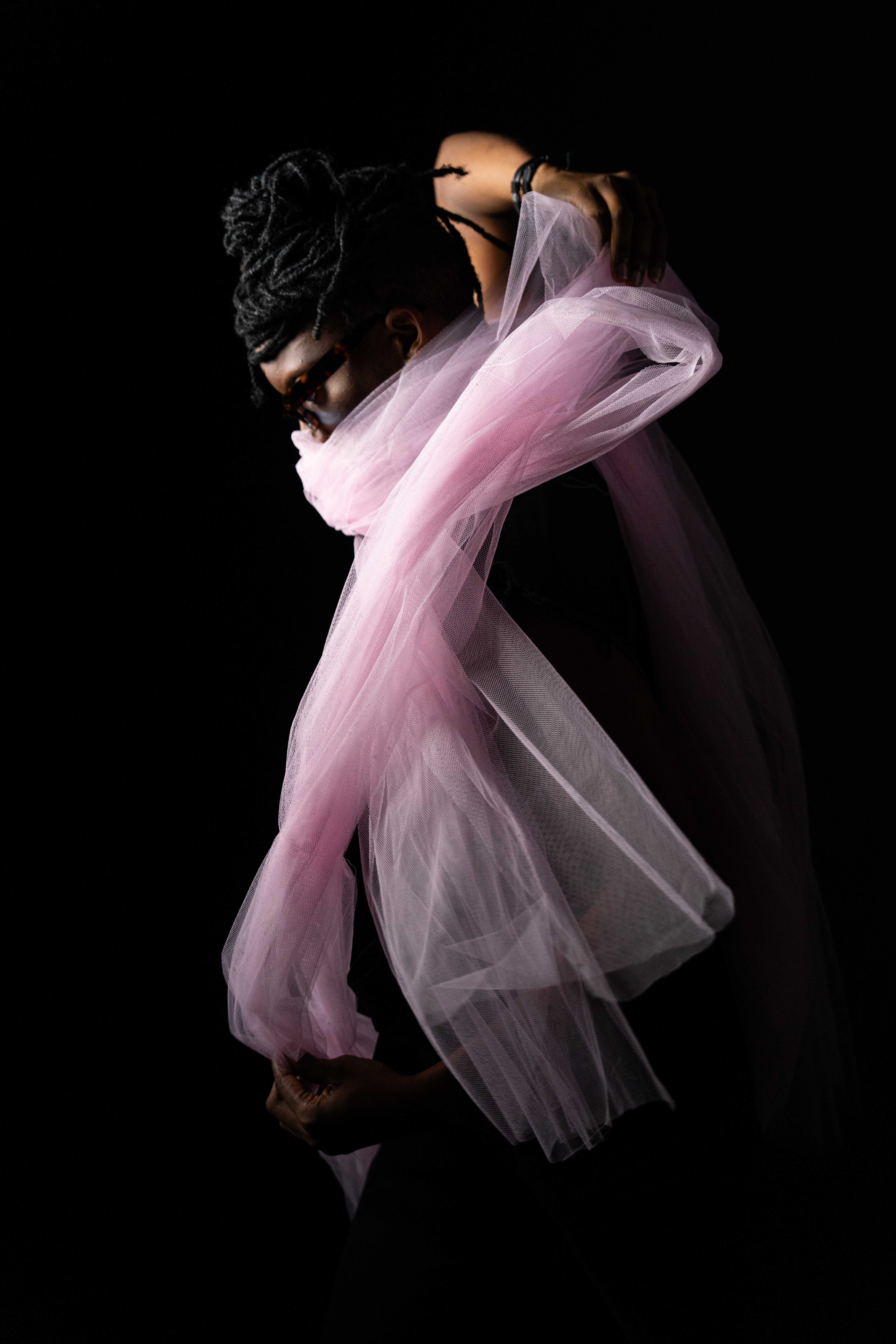 Tim by FADETOBLACK, studio portrait photography, image 13: Low-key studio portraits of a man against a black background, wrapped in flowing pink tulle