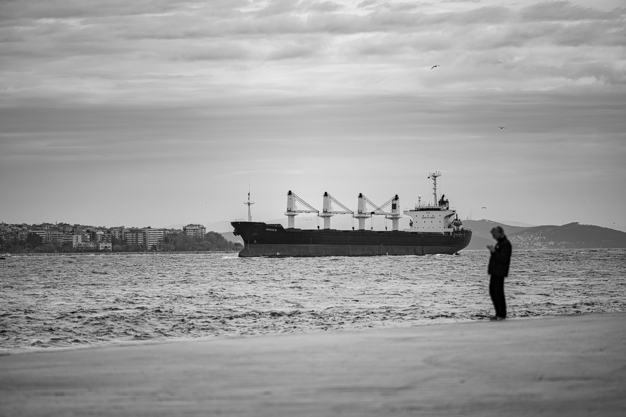 Fragments of Istanbul by FADETOBLACK, street photography, image 22: Street scenes from Istanbul: an elderly man clasping prayer beads behind his back, a cargo ship passing a